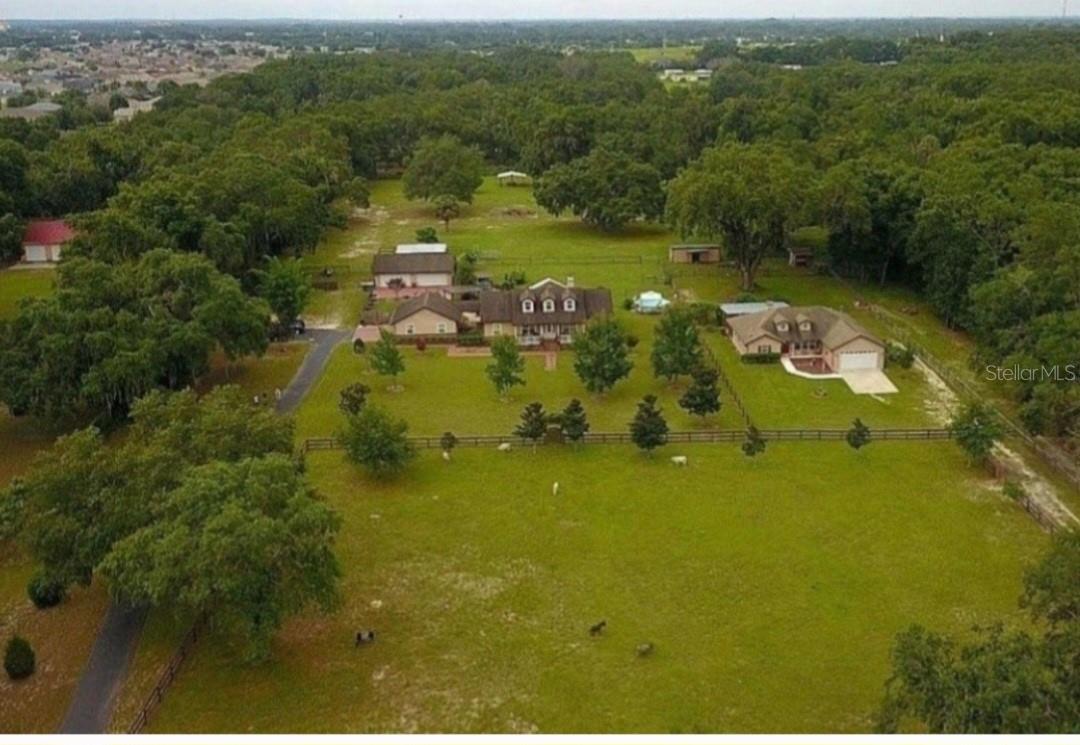 Rare Dual-Residence Concrete Block Estate on 6.7 Fully Fenced Acres in Summerfield, Florida

Exceptional multi-generational estate featuring two site-built concrete block homes, 8 total garage bays, extensive workshop space, solar power, RV guest accommodations, and fully fenced livestock-ready acreage.

Located at 10844 SE Highway 42, Summerfield, FL 34491, this unique property offers privacy, versatility, and quality construction throughout.




Main Residence (2,200 Sq Ft | Built 2006)

Beautifully updated 3-bedroom, 2-bath split floor plan home with den and expansive sunroom overlooking a peaceful Zen garden. Recent upgrades include new roof, new A/C, recent windows, recent hot water heater, remodeled kitchen, and fully renovated primary bath and custom closet.




Main home features:




- Attached 2-car concrete block garage

- Additional covered 2-car parking

- Detached 4-car concrete block workshop garage

- mother-in-law suite

Second Residence (1,600 Sq Ft)

Well-appointed 3-bedroom, 2-bath concrete block home with split floor plan, open living areas, high ceilings, attached 2-car garage, and oversized covered rear patio.




Additional Property Features




- Solar system offsetting approximately 50% of electrical usage

- 24-ft covered RV guest house with porch, electric, and sewer hookup

- 50-amp generator hookup

- Fully fenced private yard

- Tiki bar

- Pole barn

- Greenhouse

- Barn

- Chicken house

- Fully fenced pasture suitable for livestock










Ideal for multi-generational living, income-producing opportunities, homesteading, hobby farming, or workshop/business use.




A truly rare opportunity to own a turnkey Florida acreage estate offering exceptional flexibility and lifestyle potential.