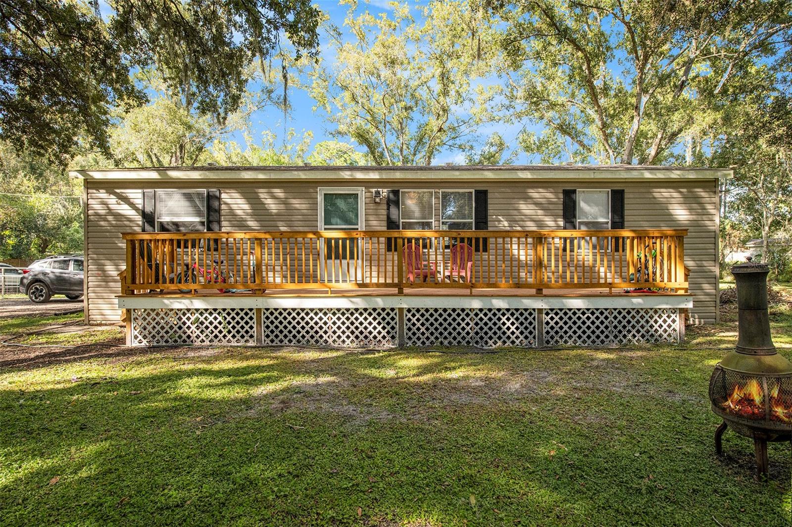 Don't miss this opportunity to own this beautiful property on over half (1/2) to an acre of land. Manufacture Home was built in 2015 by Nobility Homes, 3-bedroom, 2-bath 1296 sqft. Open floor plan with vinyl plank flooring all over the property. Gorgeous and spacious kitchen with Stainless Steel appliances and island breakfast nook with plenty of counter space. The water softener is newer 2022, AC 2022, the Septic tank was pumped out 6 months ago, and the septic tank alarm was replaced in 2022. Fenced back patio with dog run and shed. New wood deck in front of the house to sit down with your friends and family and enjoy unforgettable moments. The land is big enough to do whatever you want.  This home sits at the end of a private road.  Close to shopping, dining, and great schools. Conveniently located close to SR 54 and Suncoast highway, only 25 minutes to Tampa International Airport. You will simply fall in love with this property! FHA Buyers are Welcome!