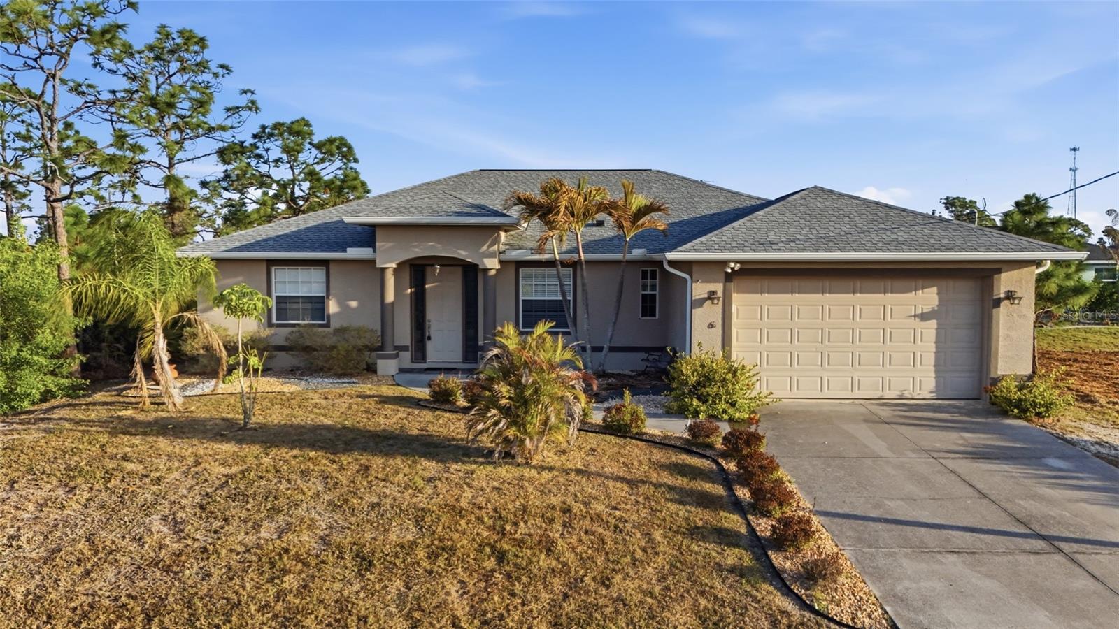 Welcome to your slice of paradise in Rotonda Sands! This beautifully maintained 3-bedroom, 2-bathroom home with a 2-car garage offers the perfect blend of comfort, style, and Florida living. CLICK ON THE VIRTUAL TOUR LINK 1 FOR THE VIDEO AND VIRTUAL LINK 2 FOR THE 3D TOUR. Step inside to a bright, open floor plan featuring tile flooring throughout and impressive high tray ceilings that enhance the spacious feel. The open living and dining areas flow seamlessly together, creating the ideal space for entertaining family and friends. A glass slider leads directly to the screened lanai, extending your living space outdoors. The eat-in kitchen has stainless steel appliances, ample countertop and cabinet space, and a center island with a high-top breakfast bar—perfect for casual dining or gathering with guests. The spacious primary suite is a true retreat, complete with a private glass slider to the lanai, a walk-in closet, and an en-suite bathroom featuring a dual-sink vanity, soaking tub, and walk-in shower. The guest bedrooms are thoughtfully positioned on a split floor plan, offering privacy and comfort with built-in closets and a shared guest bathroom nearby. Relax and unwind in the screened-in lanai—ideal for sipping your morning coffee or enjoying your favorite evening beverage. The backyard is ready for your personal touch, with plenty of room to add a pool and create your own outdoor oasis. Rotonda Sands is a quiet, deed-restricted neighborhood conveniently located near shopping, fine & casual dining spots, LIVE entertainment, biking, and boating. JUST A SHORT CAR RIDE to the Gulf Beaches of Lemon Bay, Englewood, Boca Grande, or Manasota Key to name a few where you will find world-class fishing. Schedule your showing TODAY!!
