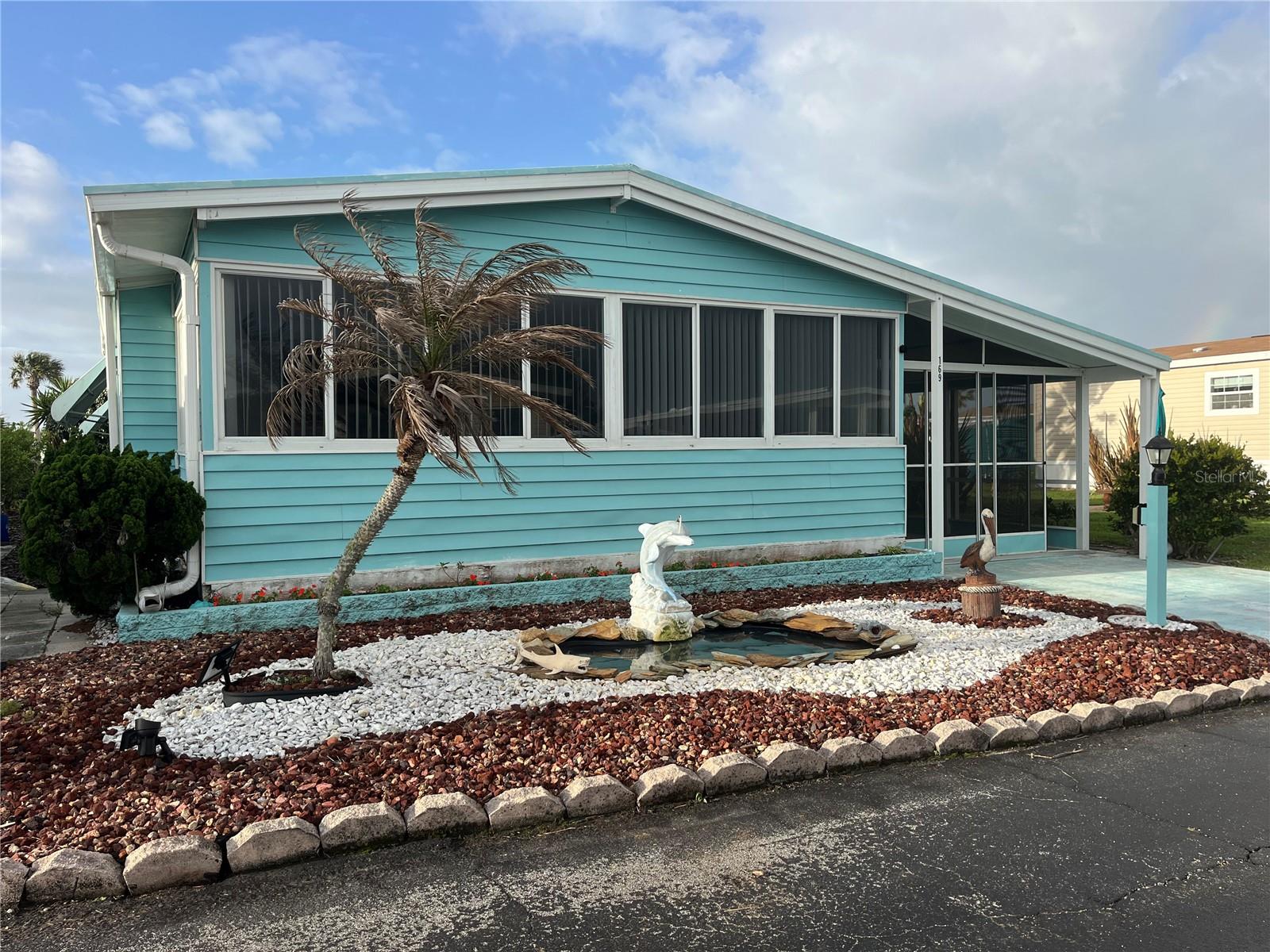 Looking for an affordable property at the beach? Don’t miss out on this furnished 2-bedroom, 2-bath coastal home located in the highly desirable Surfside Estates 55+ community. Full of charm and character, this special home offers comfortable beachside living with thoughtful updates and unique features throughout. The front Florida Room has been opened up to add additional living space, creating a bright and welcoming area to relax or entertain. A rare grandfathered fenced area in the rear yard provides the perfect spot for your furry friends, as new fences are no longer permitted in Surfside Estates. Adding to the appeal, this home is situated adjacent to one of the community’s beautifully maintained garden parks, giving you the feeling of extra outdoor space without the upkeep. The screened carport is ideal for storing your golf cart, motorcycle, bikes, or fishing gear while protecting them from the salt air, and can easily be converted back to a traditional carport if desired. Additional features include an enclosed side porch, extra storage room, and a one-of-a-kind pond feature in the front yard that adds to the home’s coastal charm. The metal roof has been professionally inspected and sealed with Lanco Urethanizer in April 2024, A/C replaced in 2018.. Located in Surfside Estates, an active 55+ resident-owned manufactured home community nestled between the Atlantic Ocean and the Intracoastal Waterway, this property offers the true Florida lifestyle. Best of all, there is no lot rent when you purchase here, you own a share of this beautiful beachside community. The low monthly maintenance fee of $220 includes Wi-Fi, internet, cable, lawn care, management, and access to all community amenities. Residents enjoy a heated/cooled inground pool, fitness room, library, shuffleboard courts, rooftop deck, kayak storage, BBQ area, gazebo overlooking the Intracoastal, and two community docks perfect for fishing, watching dolphins, or enjoying breathtaking sunsets. The active Social Calendar offers endless opportunities to connect with neighbors, including bingo nights, card games, pool tables, exercise classes, water aerobics, and more. Walk across the street to the beach or hop on your bike or golf cart and explore everything in this coastal paradise. Just minutes away, the charming town of Flagler Beach offers local restaurants, shopping, and entertainment, while nearby mainland conveniences include hospitals, doctors, and additional shopping. Come experience this charming beachside getaway and claim your own piece of paradise!