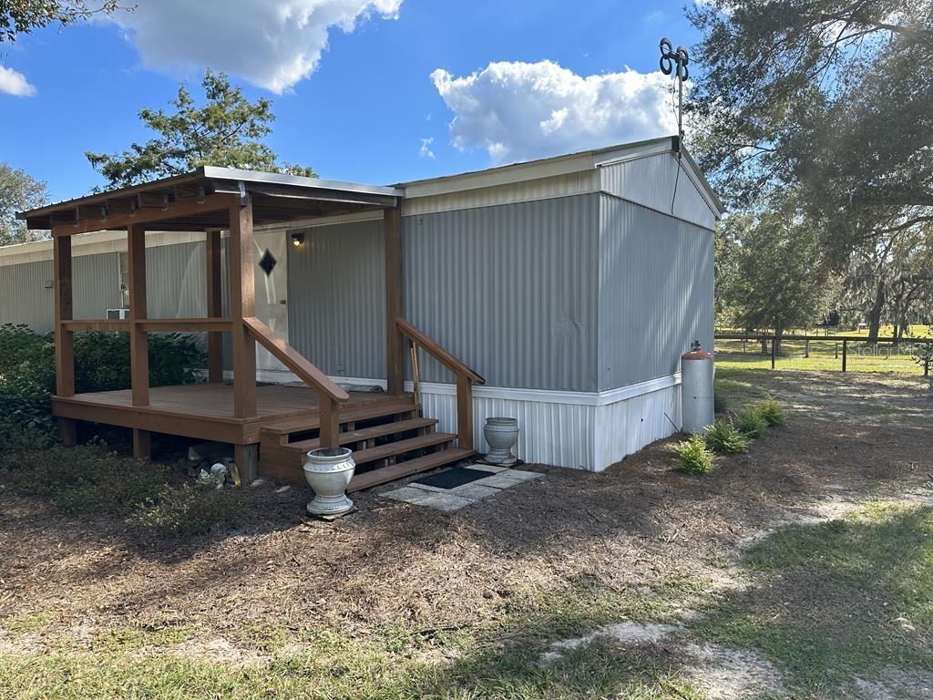 Come take a look at this 10.3 ACRE HORSE PROPERTY with 2 HOMES! Gorgeous fenced pastures in the front, side and back of the property for grazing horses or other livestock. In the center of the property there is a 1990 singlewide manufactured home with an addition on it and a 1988 2-story tiny home. The mobile home has vinyl flooring and wood laminate throughout and a metal roof. The tiny home has vinyl flooring and wood laminate, where the top floor is currently utilized as a loft storage area. The tiny home also has a metal roof and offers a covered porch to sit out on and drink your morning coffee! A large metal workshop on concrete with electric service and plenty of room for storage is useful to store tools, feed, small equipment and the barn has 2 stalls and tractor/hay storage. The property is located only 5 minutes from the Gilcrest Horse Training Center and track for harness horses. Located right off paved road County Road 232 for an easy commute to Gainesville for work, but still in Gilchrist County with low property taxes and "A" rated schools. Call today to schedule your private showing!