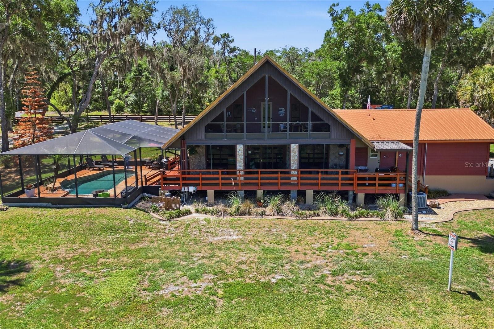 Motivated Seller. Set on 2.37 acres in Inverness, this 3-bedroom, 2.5-bath two-story home offers canal frontage with access to Lake Hernando and the Withlacoochee River by airboat. During periods of higher water levels, the canal also provides pontoon access to Lake Hernando. The property includes approximately 600 feet of canal frontage, a private dock, boat ramp, electric entry gate, saltwater screened pool with waterfall feature, rear deck, tiki hut with bar area, detached RV/boat storage building, and a three-bay covered carport. Water levels are currently low due to drought conditions; however, the canal system remains accessible by airboat and continues to connect through the surrounding canal network. RV hookups with 30 AMP service, separate septic connection, and a storage shed with washer and dryer hookups.

Inside, the home features vaulted ceilings, updated flooring, and an open living area overlooking the water. The kitchen includes quartz countertops, custom cabinetry, stainless steel appliances, wine fridge, farmhouse sink, and a large island with cooktop and seating. The main-level primary suite includes dual vanities and an oversized tiled shower with dual shower heads. A mudroom with half bath provides direct access to the rear deck leading to the pool area. Upstairs, the third bedroom includes a full bath and access to a screened balcony connected by an interior catwalk overlooking the main living space and canal.

Additional updates include a 2019 metal roof, 2025 gas tankless water heater, 2025-installed 500-gallon underground propane tank, and 2025 drainfield replacement. The property is serviced by well and septic and has no HOA.

Inside, the home features vaulted ceilings, updated flooring, and an open living area overlooking the water. The kitchen includes quartz countertops, custom cabinetry, stainless steel appliances, wine fridge, farmhouse sink, and a large island with cooktop and seating. The main-level primary suite includes dual vanities and an oversized tiled shower with dual shower heads. A mudroom with half bath provides direct access to the rear deck leading to the pool area. Upstairs, the third bedroom includes a full bath and access to a screened balcony connected by an interior catwalk overlooking the main living space and canal.

Additional updates include a 2019 metal roof, 2025 gas tankless water heater, 2025-installed 500-gallon underground propane tank, and 2025 drainfield replacement. The property is serviced by well and septic and has no HOA.