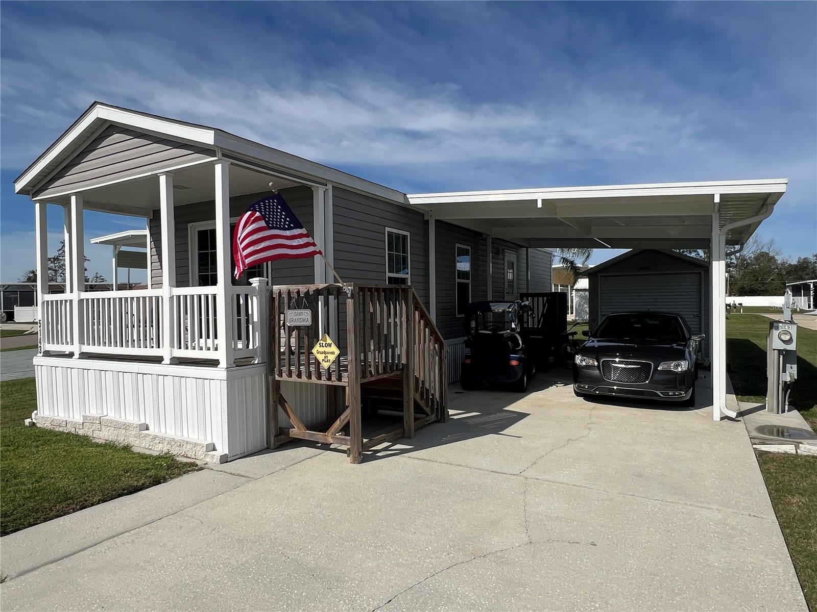 Discover refined RV living in this exceptional 2019 Live Oak manufactured home located in Phase 4 of Mount Olive Shores. Fully furnished and meticulously maintained, this residence delivers immediate comfort and turnkey convenience within one of Central Florida’s premier Class A motorcoach communities.

The home includes a covered carport, all major appliances, ceiling fans, and window treatments—allowing you to move in and begin enjoying the lifestyle right away. A spacious 200-square-foot air-conditioned shed adds substantial value, complete with a washer and dryer plus additional storage space.

Designed with the Class A enthusiast in mind, the expansive concrete motorhome pad accommodates virtually any length coach and provides full public utility hookups for seamless setup.

The annual HOA fee covers basic lawn care and common area maintenance, preserving both curb appeal and ease of ownership. Ideally positioned just 3.5 miles from I-4, the community offers convenient access to shopping centers, major medical facilities, Tampa and Orlando International Airports, and Central Florida’s world-renowned attractions—all within approximately one hour.

Mount Olive Shores now features a brand-new 5,000-square-foot heated and cooled Community Center that significantly enhances the resident experience. This impressive facility includes:
 • Full kitchen
 • Regulation-size pool and shuffleboard tables
 • Dart board and arcade games
 • Dedicated card room and library
 • Vending area
 • Covered BBQ lanai for gatherings

An active social calendar rounds out the lifestyle, with seasonal events such as Bingo, karaoke nights, potluck dinners, holiday celebrations, and numerous community activities throughout the year—creating consistent opportunities for connection and engagement.

Please note: Mount Olive Shores is a gated, deed-restricted Class A motorhome community. Ownership or Lease of a Class A motorhome is required the first year of residency to maintain the integrity and focus of the neighborhood.

This is more than a home—it is a well-structured lifestyle investment in one of Florida’s most established RV communities.