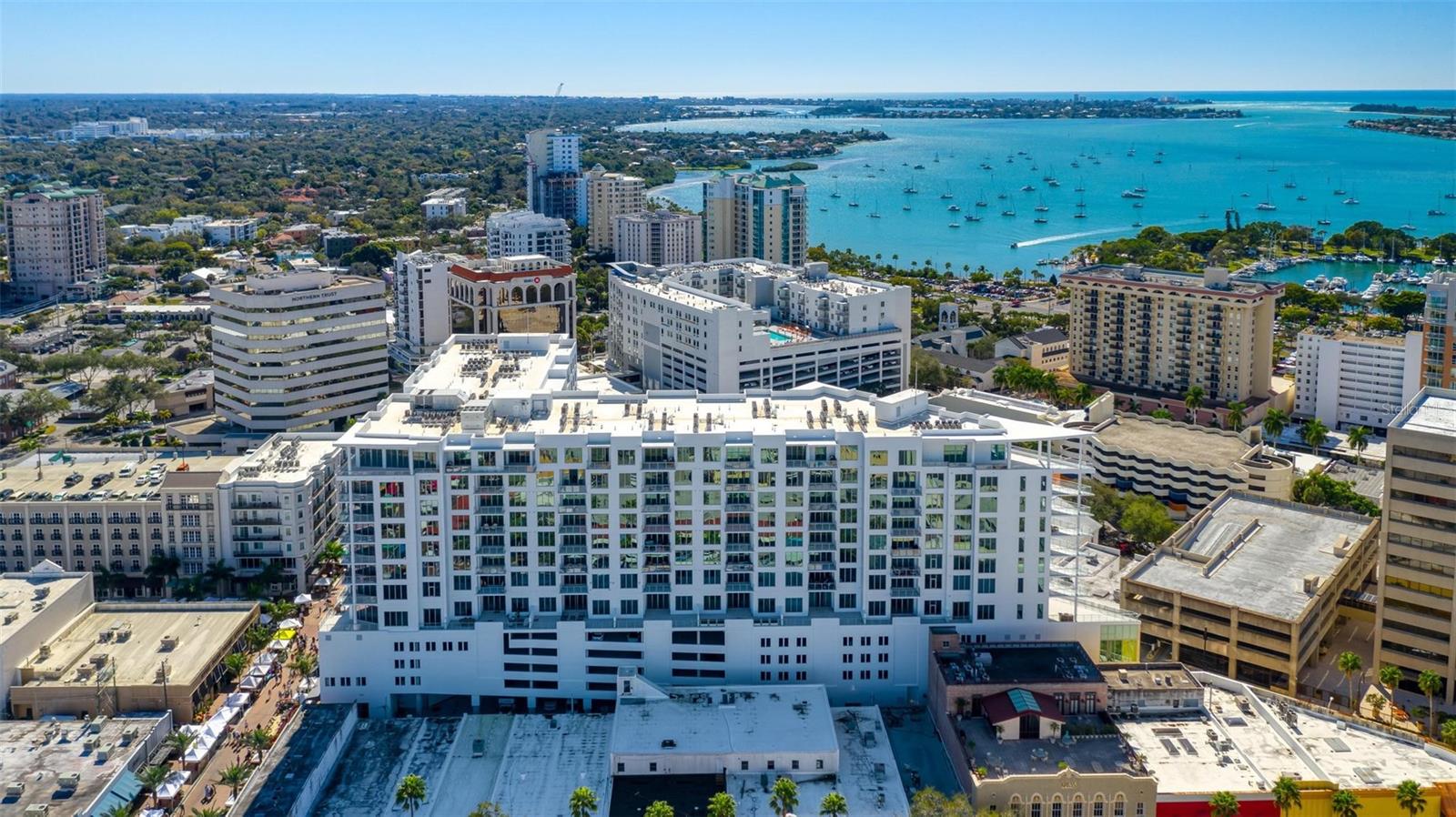 Exquisite, elegant, and serene living in the heart of splendid downtown Sarasota! Enjoy the morning on your balcony with your coffee in hand as you enjoy the bird’s eye views, and evenings relishing the Gulf breezes. This gorgeous condo is impeccable with European cabinetry, quartz countertops, custom woodworking, porcelain tiles, refreshing, subtle color palette, California Closets, and more! The open, expansive floor plan boasts natural light galore inspiring a cheery, light-hearted ambiance. The split bedroom layout allows for privacy and generous breathing space when entertaining guests. The primary bedroom is spacious and delightfully opens to the balcony for fresh air, complete with a thoughtfully designed walk-in closet, and a pristine en suite bathroom with dual vanities. The airy guest bedroom and en suite are perfect for hosting family and friends. There is a den for work or hobbies, and a powder room for guests. Spend afternoons by the glorious 65-foot infinity pool with peek-a-boo views of the Gulf! Enjoy all of the splendid, convenient amenities that The Mark offers to compliment your lifestyle: fire pit lounge, cabanas, outdoor grills, fitness center, spin room, clubroom with catering kitchen, pool table, café-style office space, 24-hour staffed reception, pet-friendly, security, an assigned parking space, and a separate secured storage unit. Saunter around downtown Sarasota, shop at the Saturday Farmers' Market, savor the authentic lemon tarts at C’est La Vie, attend the Sarasota Ballet or Orchestra, the lush gardens of Selby, and dozens of delightful restaurants and cafes! Enjoy sunny beach days at Lido Key and powdered sugar-soft beach walks. Evening strolls at the marina only a few blocks away, boutique shopping and street musicians at St. Armand’s Circle, or pop out for a last-minute cocktail at sunset with friends. The Mark is the epitome of downtown easy, breezy, luxury living!