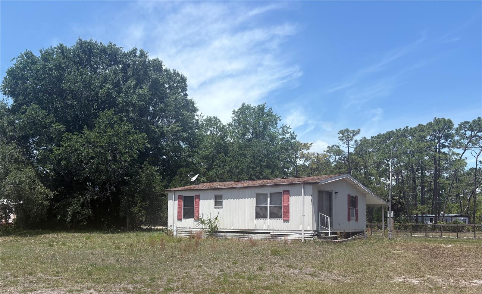 Handyman special in Homosassa. Nestled on a peaceful half an acre, this 2 bedroom, 1.5 bath home is close to the Chassahowitzka River and Seven Sisters Springs. This home features a functional layout, an updated kitchen, and a new fence and gate. With no HOA restrictions or lot rent, you have the freedom to use the property as you see fit. It is located less than one hour to Tampa International Airport with easy access to the Suncoast Parkway, plus close to numerous springs, rivers and the Gulf. This property is perfect as an investment, a seasonal getaway or a full-time residence. This cozy home needs TLC - bring your vision and unlock the full potential of this property.