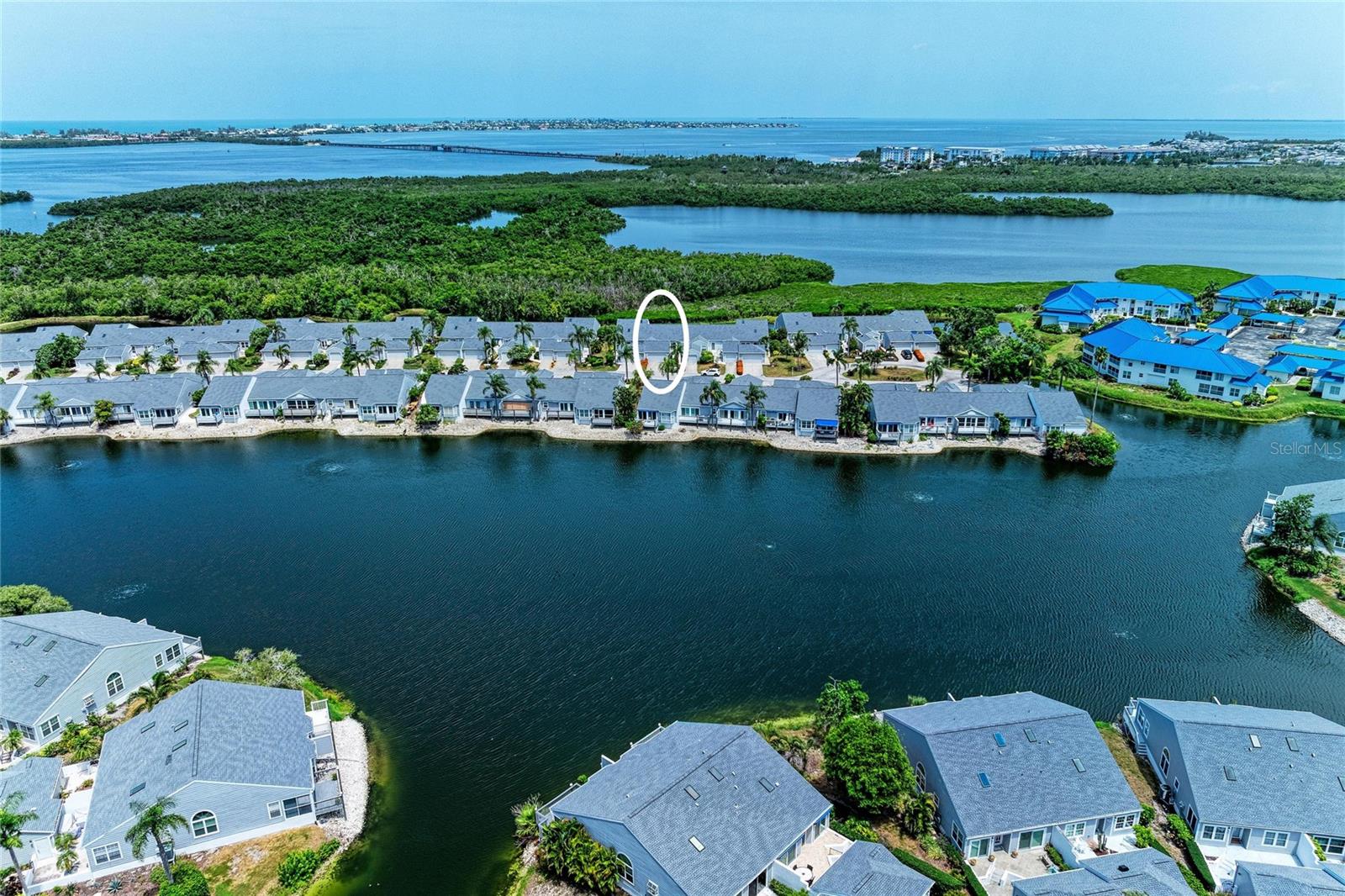 Come enjoy resort-style living at 1218 Spoonbill Landings Circle in the highly sought-after Perico Bay Club, where coastal beauty, nature, and recreation come together to create an exceptional Florida lifestyle. From the moment you step inside, you'll be captivated by the tranquil preserve and water views that create the perfect backdrop for everyday living. This beautifully furnished waterfront villa offers 2 bedrooms, 2 baths, and a spacious 2-car garage. The inviting open floor plan features soaring ceilings, large white tile flooring throughout, and an abundance of natural light. The spacious living area is enhanced by custom built-in shelving with illuminated display niches and a wall of sliding glass doors that opens to your private deck overlooking the water and preserve. The kitchen has been opened up to enjoy the living space and bar seating at the high counter. The fully stocked kitchen has ample white cabinetry with convenient access to your full sized washer and dryer. Large kitchen windows with views to your private courtyard. Primary bedroom has its own slider to your private, full length back porch, as well as volume ceilings, a walk in closet, and an en suite bath with glass enclosed walk in shower. Your guest suite also enjoys the high ceilings, and a walk in closet with extra shelving and easy access to the second full bath.. Recent upgrades include: NEW Roof 2025, NEW AC 2025, NEW Electric Panel Box 2025, NEW Hot Water Heater 2025, New Deck 2025, NEW Dryer 2025. At Perico Bay Club there are numerous amenities...active clubhouse, with fitness center, tennis & pickle ball & shuffleboard courts, kayak storage & launching dock, heated community pools with hot tubs & a boardwalk leading out to Perico Sound for bird watching. Ideally situated near Neal Preserve and Perico Preserve, and just moments from over 600 acres of Robinson Preserve, residents enjoy miles of hiking and biking trails, kayaking through scenic coastal waterways, and abundant wildlife. The pristine beaches and turquoise waters of Anna Maria Island are only two miles away.  Plus, all the gourmet restaurants & shoppes on the Island. While De Soto National Memorial, Palma Sola Botanical Park, Cortez Fishing Village, and the Bradenton Riverwalk are all conveniently located nearby.