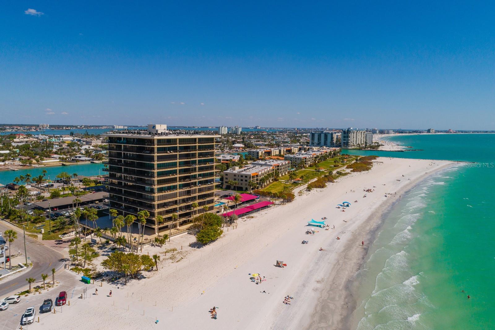 Stunning panoramic waterfront views of Sunset Beach, the Gulf of Mexico, and the Intracoastal Waterway highlight this premier 11th-floor corner residence. This rare 2 units combined offers 3 bedrooms, 3 bathrooms, 3 covered parking spaces, 2 storage closets and 2,940 sq. ft. of living space, plus 120 linear feet of wraparound balconies overlooking turquoise waters and silky sand beaches. An incredible opportunity to remodel to create your own custom beachfront residence. Mansions by the Sea is a gated community featuring resort-style amenities, including tennis/pickleball courts, a beachside heated pool, fitness center, and social clubhouse.