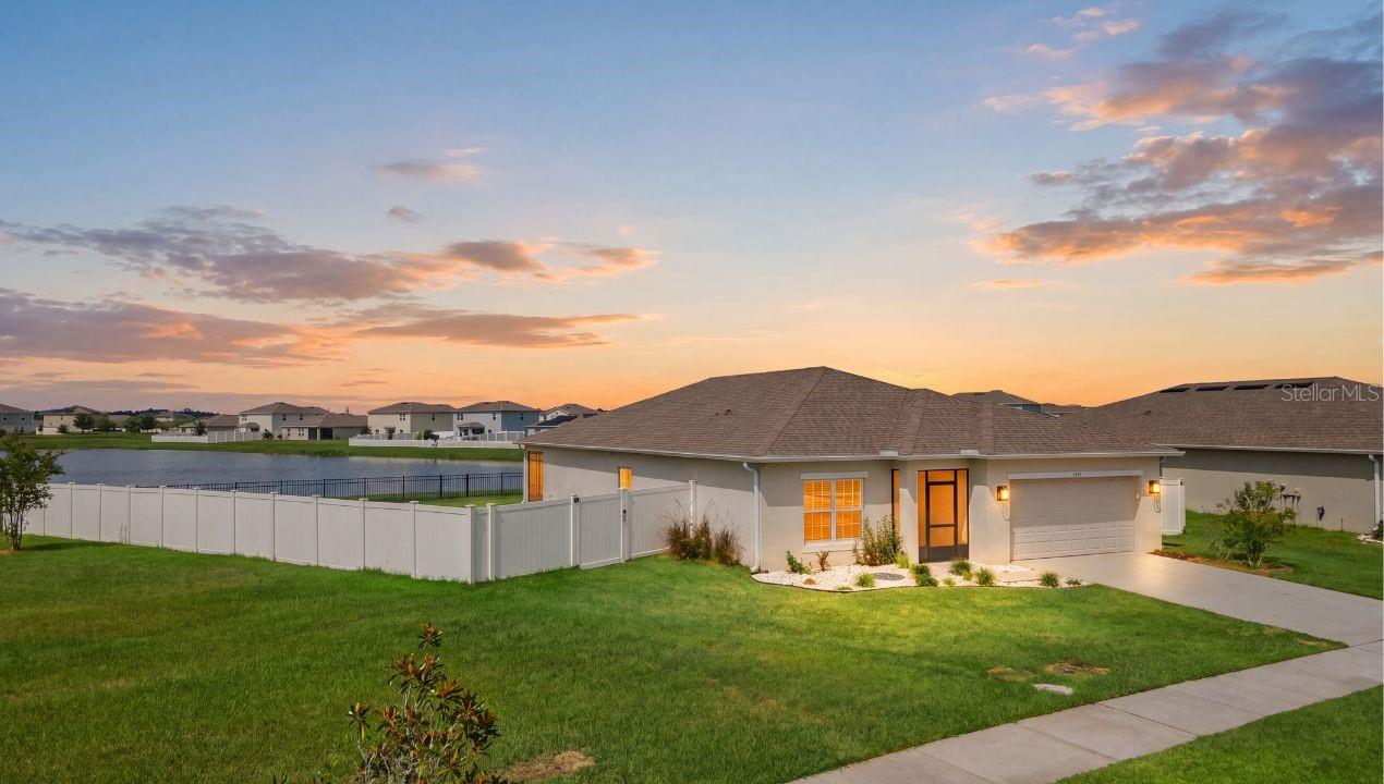 Virtually Staged. PRISTINE ONE-OWNER HOME FEATURING AN OPEN CONCEPT DESIGN, TRANQUIL WATER VIEWS, AN OVERSIZED QUARTER-ACRE HOMESITE, AND THOUGHTFUL UPGRADES THROUGHOUT IN THE HIGHLY DESIRABLE STEPPING STONE COMMUNITY! Beautiful landscaping, a manicured lawn, and a screened front porch create exceptional curb appeal and a warm welcome. Inside, the open-concept layout is filled with natural light and showcases updated lighting, ceramic tile flooring, luxury vinyl plank flooring, and a spacious kitchen featuring an oversized island, custom backsplash, walk-in pantry, premium LG French-door refrigerator, and water filtration system. The dining and gathering areas flow seamlessly to the screened lanai, where tranquil water views create the perfect backdrop for relaxing or entertaining. Privately tucked away, the primary suite offers a designer chandelier, accent wall, walk-in closet, and ensuite bath. Outside, the fully fenced backyard combines vinyl fencing with wrought iron view fence that preserves the peaceful water views, along with new gutters, motion activated floodlights, extra electrical outlets and hose bibs. Secondary bedrooms are spacious and inviting, while added laundry storage, bidets in two baths, and an epoxy-coated garage floor reflect the home’s exceptional pride of ownership. Located in Taylor Morrison’s Stepping Stone community with sidewalks, convenient access to Poinciana Parkway, and minutes away from the new Poinciana Poinciana Lake Plaza featuring retail and dining options.