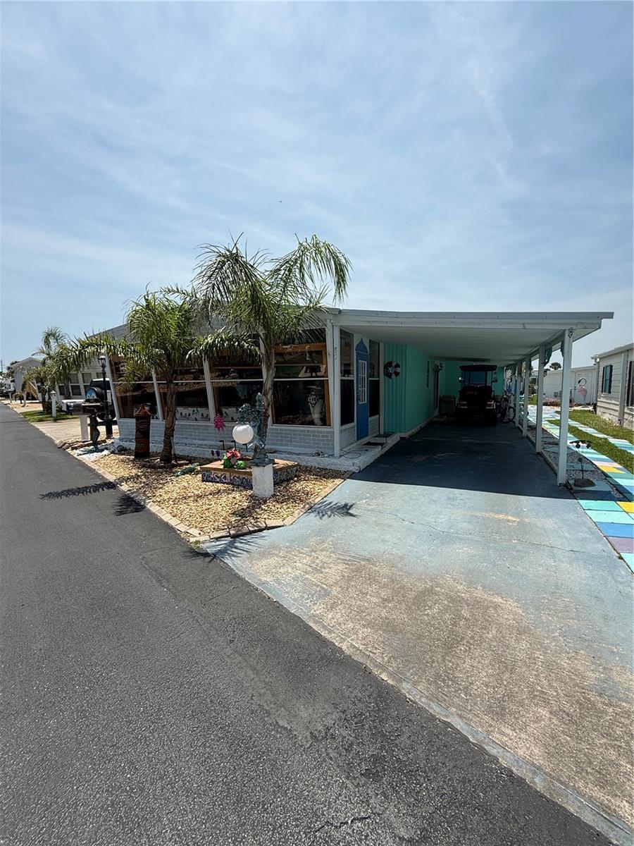 Newly reduced artist retreat beachside. This two bedroom, two bath free-spirited home is the artist's canvas!  The interior is painted in fabulous colors and unique details.  The living area is open to the enclosed porch, allowing for a nice flow.  This is truly a home you would need to see to appreciate. Handcrafted shutters and intricate fence on the exterior reflect the owners' style.  Painted flooring throughout for easy beach living! Enjoy you morning coffee in the Florida room before walking or riding over to the beach or to the Intracoastal to fish. 
Surfside Estates is a resident owned co-op community, located along the Intracoastal Waterway, just across the street from the beach and where you own your lot-share and never pay rent. The community has a low maintenance fee of $220 each month that includes cable TV, high-speed internet, lawn service, heated saltwater pool, two fishing piers and clubhouse. The clubhouse has a kitchen, pool tables, TV, library, fitness center and shuffleboard. Along the Intracoastal, you will find a screened gazebo, fire pit, barbecue, benches, horseshoe pits, the two partially covered fishing piers, kayak racks and launch. With an active Social Club, you can choose from yoga, pool aerobics, an ice cream social, Bingo, pool teams, card tournaments, karaoke, dances, community breakfasts, potluck dinners, and so much more! Or take a walk, ride your bicycle, drive your golf cart around the friendly neighborhood. Either way, there seems to be something for everyone.
