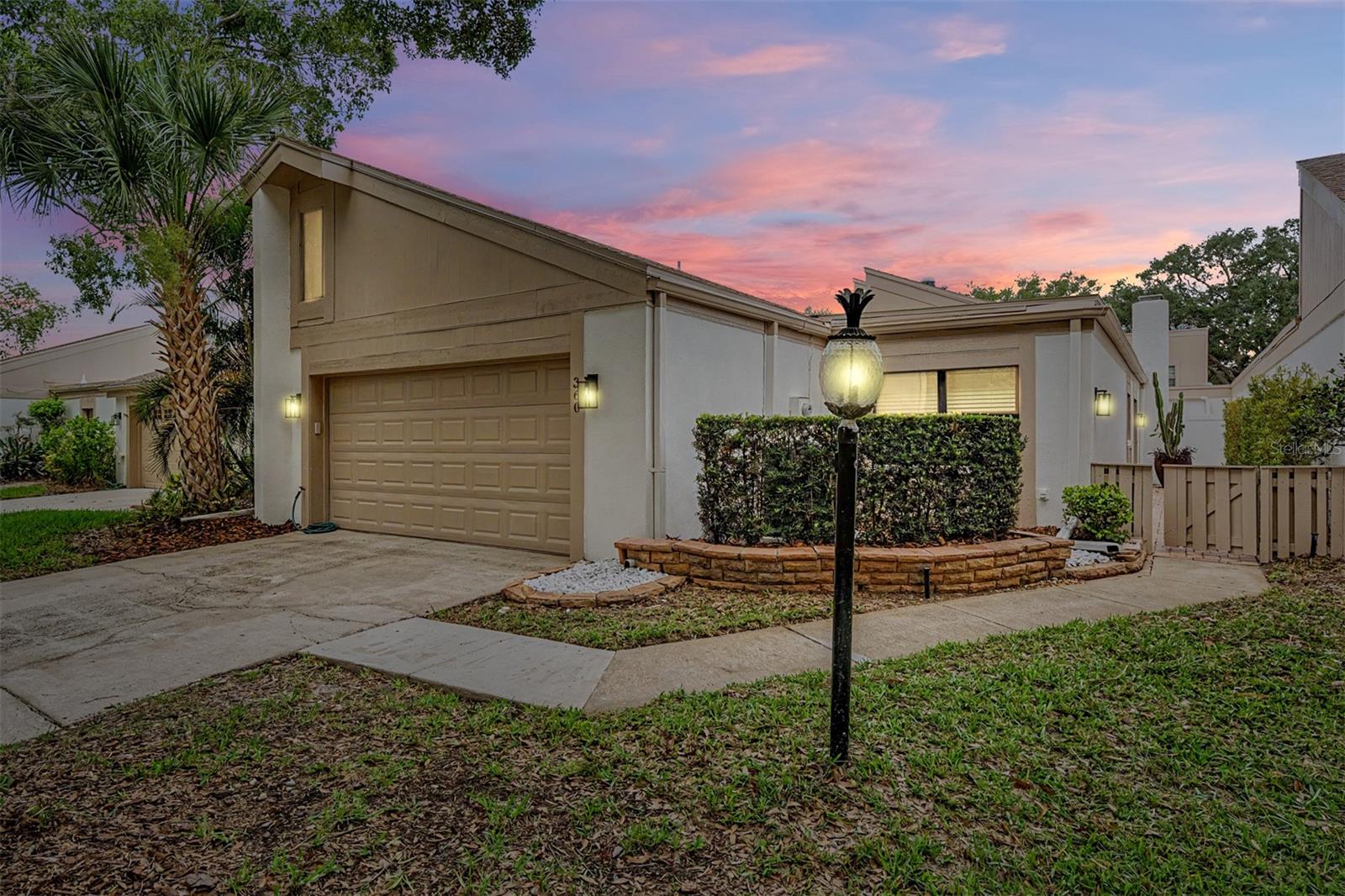 Welcome to 360 S Woodlands Drive, a beautifully renovated 2-bedroom, 2-bath patio home nestled within the prestigious gated community of East Lake Woodlands in Oldsmar. Offering 24-hour guarded security and a maintenance-free lifestyle, this move-in ready residence combines modern upgrades with exceptional privacy and comfort. NEW ROOF + FLAT ROOF (2025)! NEW AC (2025)! Extensively updated throughout, the home features luxury vinyl plank flooring installed in 2022, a completely remodeled kitchen with granite countertops, premium cabinetry, and stainless steel appliances, along with two beautifully renovated bathrooms featuring updated tilework, granite countertops, and stylish vanities. The spacious primary suite serves as a private retreat with a custom-designed closet and an oversized soaking tub perfect for relaxation. Additional improvements include IMPAC impact windows, a new flat roof installed in December 2021, updated interior doors, and a custom 45-foot paver walkway that extends from the front entrance to the private rear patio, creating an ideal outdoor space for entertaining or enjoying Florida's beautiful weather. The HVAC system was replaced in 2025 for added peace of mind.The monthly HOA fee provides true maintenance-free living and includes lawn care, irrigation, Spectrum cable and internet service with two cable boxes, and exterior painting every five years. Residents also have the option to join East Lake Woodlands Country Club, offering two championship golf courses, tennis courts, swimming pools, fitness facilities, dining, and a vibrant social calendar. Ideally located near shopping, dining, parks, Tampa International Airport, and some of the area's most beautiful Gulf Coast beaches, this exceptional home offers the perfect blend of luxury, convenience, and Florida living. Schedule your private showing today.
