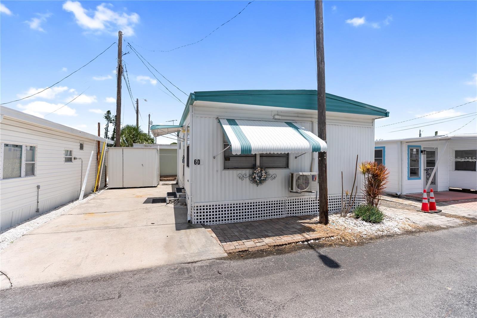 Welcome to your slice of paradise in the highly sought-after 55+ community of Paradise Bay Estates! Offered completely turnkey and move-in
ready, this home is designed for comfort and ease. This delightful 1BR/1BA home features a cozy living area and kitchen with a dining area too. One shed even includes a washer/dryer hookup for added convenience. The main bedroom currently features a queen bed. Plus, a brand-new split system heat/AC was installed in December 2024 after the home received a refreshing update post-hurricanes Helene & Milton. Paradise Bay Estates is an active and vibrant community with fantastic amenities, including a heated pool and spa, pickleball courts, shuffleboard, a boat ramp, and available boat dockage (waitlist applies). There’s always something happening—from potlucks and musical shows to golf outings, community lunches, and music by the bay. Nestled along the picturesque shores of Sarasota Bay, residents enjoy stunning wildlife, charming gazebos, and breathtaking sunsets over Anna Maria Island and Longboat Key. Don’t miss this opportunity to enjoy the Florida lifestyle in a premier waterfront community!