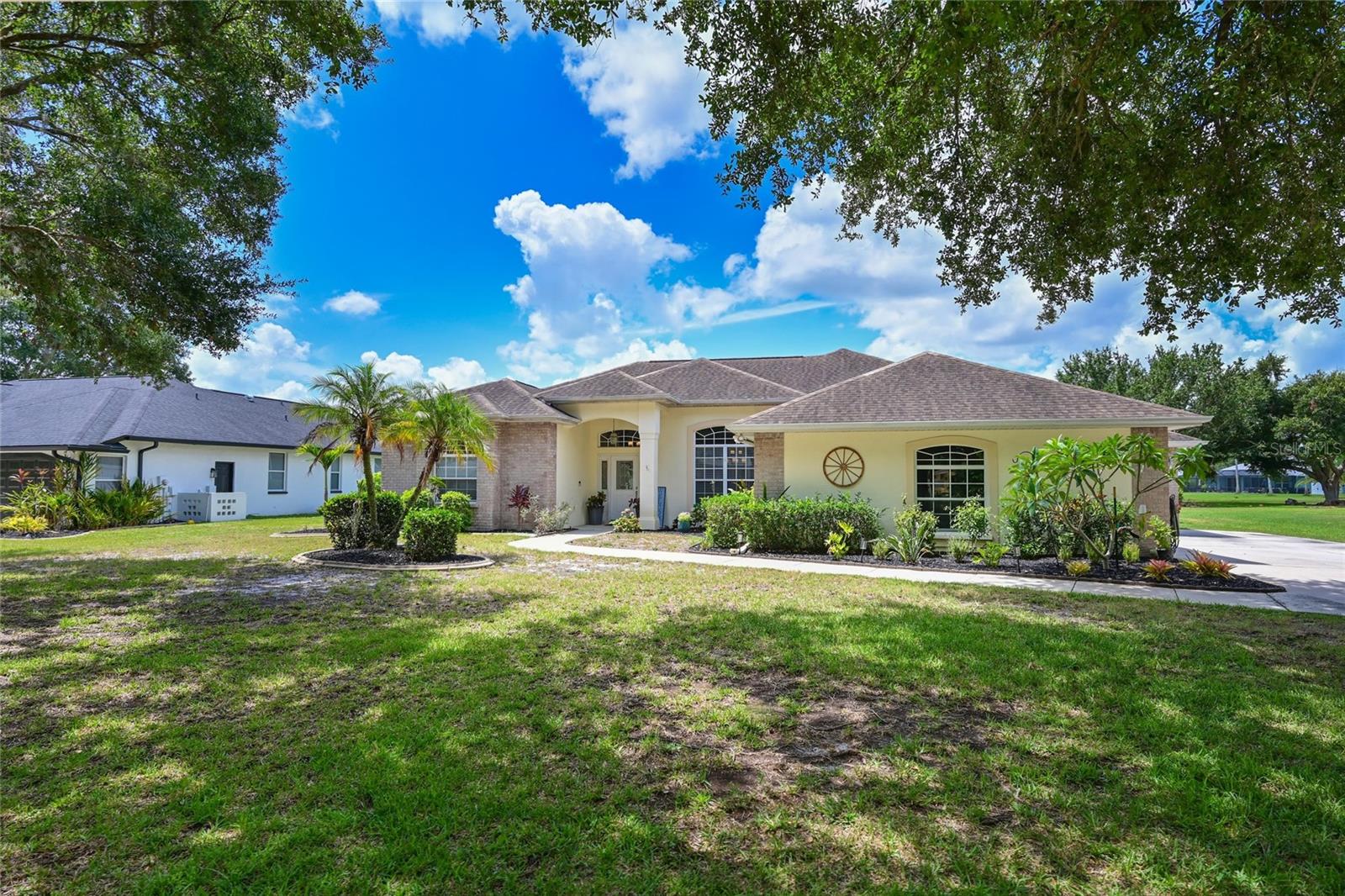 Lakefront Living on a Half-Acre.  Perfectly positioned on a spacious half-acre homesite with tranquil lake views, this beautifully maintained 4-bedroom, 3-bath pool home offers 2,303 square feet of thoughtfully designed living space complete with an oversized 2-car garage plus a dedicated golf-cart-size garage.  Step inside to discover formal living and dining areas enhanced by architectural details and tall ceilings, creating an open and inviting atmosphere. The updated kitchen is a delightful feature showcasing quartz countertops, new appliances (2024), tile backsplash,  pantry, and abundant counter space—ideal for both everyday living and entertaining. The kitchen seamlessly opens to a large family room with sliding glass doors that lead to the lanai and pool area.  Breakfast bar and a charming eat-in breakfast nook features aquarium glass windows, offering picturesque views of the pool and serene lake beyond.  The spacious primary suite provides a private retreat with luxury wood flooring, complete with a walk-in closet and an en suite bath featuring dual vanities, a garden tub and a separate shower. This popular split floor plan includes two additional bedrooms that share a bath, while the fourth bedroom and full bath are tucked away—perfect for guests or a private home office.  Outdoor living is truly exceptional. Enjoy the screened lanai and sparkling pool with stunning lake views, along with a covered patio area perfect for grilling and relaxing year-round. Notable updates include:  Pool resurfaced (2025), Pool heater (2020), New lanai screening (2024).  Additional features include:  Roof (2017),  A/C (2018), Water heater (2020), 5¼-inch baseboards, Gutters and irrigation system, luxury vinyl flooring in bedrooms, and a 50-amp generator hookup in the garage. Laundry has sink, cabinets and washer and dryer that stay.  With low HOA fees and no CDD, this home offers exceptional value within an established community. Conveniently located near top-rated schools, shopping, dining, and with easy access to I-75, commuting to Tampa, St. Petersburg, and Sarasota is effortless.