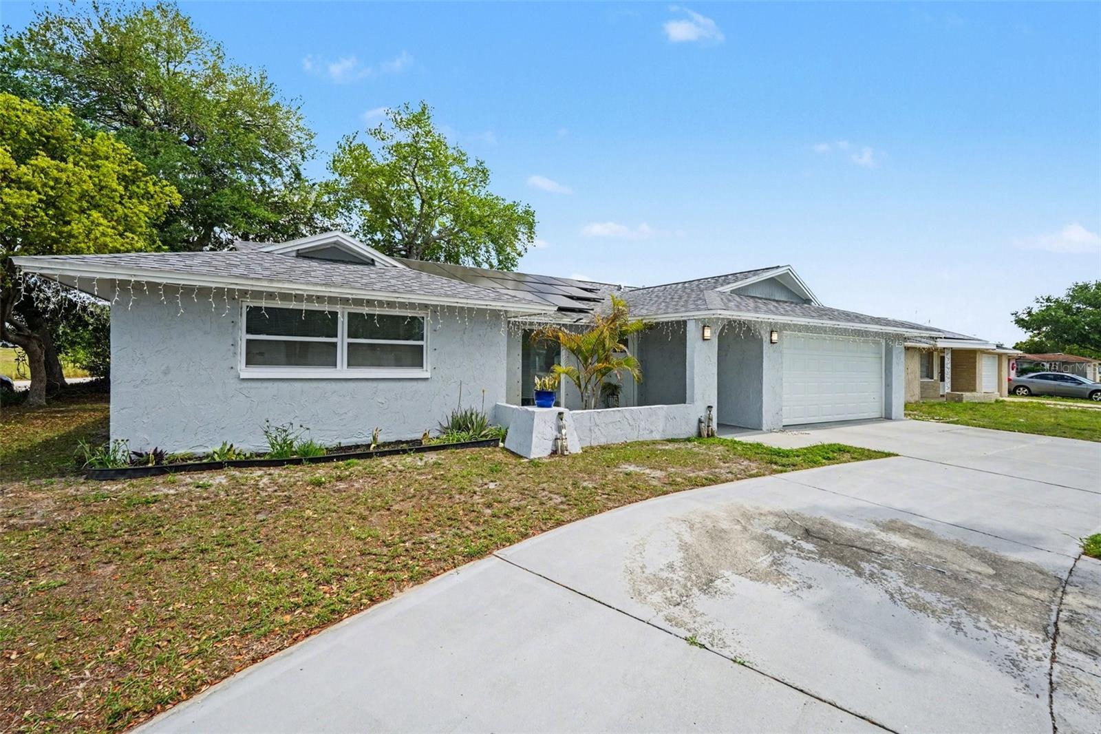 Stop searching for "new" and step into this meticulously updated 4-bedroom, 3-bathroom sanctuary. Located on a spacious corner lot in Port Richey, this home offers the perfect blend of peace of mind and modern style. Every major detail has been handled: a new roof (2020), a new HVAC system (2020), and all-new windows and doors (2021) to ensure energy efficiency and comfort.

The heart of the home is a stunning kitchen equipped with quartz countertops and stainless steel appliances, overlooking a massive screened-in pool area. With a brand-new pool pump and filter installed in 2025, your private oasis is ready for summer. The interior boasts nearly 2,000 sq. ft. of carpet-free space, featuring all-tile flooring and designer finishes in every bathroom.

For those who need space, the circular driveway and corner lot provide abundant parking for toys, boats, or an RV. Best of all, this property sits in a preferred No-Flood Zone and has zero HOA or CDD fees. Positioned just minutes from the US-19 and SR-52 corridors, you are close to everything while feeling worlds away. Don’t miss out on this turn-key residence—this one won’t last.