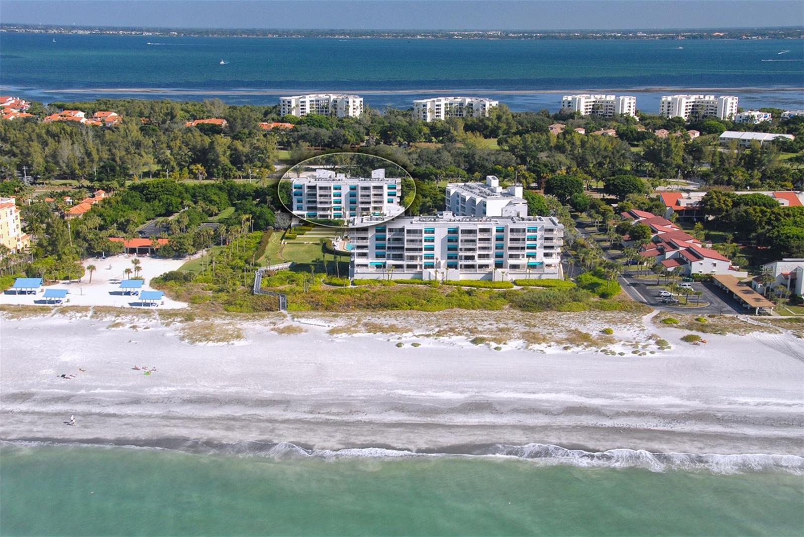 Discover effortless beachfront living in this beautifully renovated 2-bedroom, 2-bath residence. A rare opportunity to own a refined boutique beachfront escape of only 65 residences—where sophistication meets the relaxed elegance of Gulf Coast living. Captivating Gulf views are enjoyed from EVERY room. The light and airy interior welcomes you with a sun-filled, open-concept layout framed by floor-to-ceiling impact glass windows capturing breathtaking Ocean vistas. The living, dining, and kitchen spaces connect seamlessly, creating a welcoming environment for both entertaining and everyday relaxation. The renovated kitchen is thoughtfully designed for modern coastal living, complete with Cambria quartz countertops, an oversized island perfect for meal prepping as well as breakfast seating, LG stainless steel appliances, and soft-close cabinetry complete the package. Step onto the private balcony to enjoy morning coffee or evening cocktails as spectacular vibrant sunsets unfold over the water and paint the sky. The primary suite serves as a tranquil coastal sanctuary, featuring expansive Gulf views, the gentle rhythm of the surf,  spacious walk-in closet, and a beautifully appointed ensuite bath. 
The guest bedroom provides both privacy and beautiful water views, making it ideal for hosting friends and family. An interior laundry room with additional cabinetry adds convenience and functionality. Covered under-building parking and additional storage complete this exceptional offering. Sunset Beach, an intimate private beachfront community without the crowds of a larger complex but still offers resort-inspired amenities including a heated pool, spa, fire pit, BBQ grills, and direct access to powdery white sand beaches just beyond your doorstep.
Ideally positioned near St. Armands Circle, the Longboat Key Club, marinas, dining, shopping, and entertainment, this home offers the perfect balance of location and coastal beauty. 
A rare opportunity to own an exceptional Gulf-front retreat designed for the relaxed rhythm of island life. (Second bedroom virtually staged)