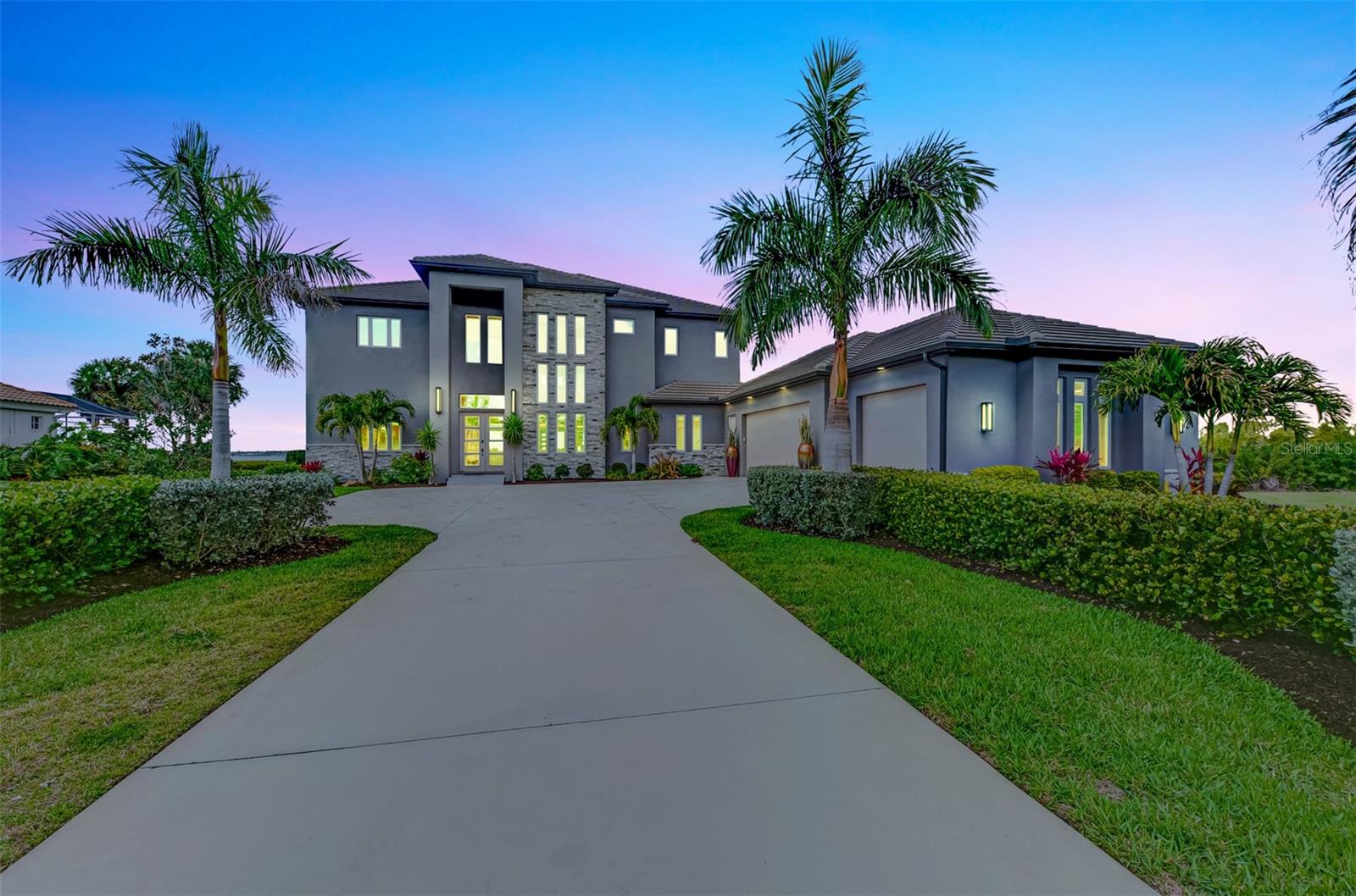 RIVERSIDE of RIVERWOOD – Exclusive Modern Florida Living on a Grand Scale. Captivating panoramic views of the Myakka River, lush preserves, and breathtaking sunsets are enjoyed from every level of this spectacular 2021-built riverfront estate. This well-constructed two-story residence with private elevator offers 4 bedrooms, 4.5 baths, a den, and over one acre of prime waterfront property, truly a rare riverfront jewel. From the moment you arrive, the architectural curb appeal impresses. An extended palm-lined driveway leads to an oversized three-car garage plus golf cart bay. The welcoming foyer opens to a dramatic great room with soaring 22-foot coffered ceilings and a wall of glass framing the expansive lanai, resort-style pool and spa, and tranquil river beyond. Contemporary design, superior craftsmanship, and designer lighting, window treatments, tile, fixtures, and flooring are showcased throughout. The gourmet kitchen is designed for entertaining, offering sprawling granite countertops, oversized center island, wet bar, walk-in pantry, top-of-the-line appliances, and adjacent formal dining. Tray ceilings, abundant windows, and sliding glass doors flood the home with natural light, creating seamless indoor-outdoor living. The main level features a private en-suite bedroom, den with direct lanai access, second bedroom ideal as an office, half bath, and ample storage. Outdoor living is exceptional with a fully equipped kitchen with gas grill and smoker and convenient full pool bath. Ascend the decorative wood staircase or elevator to the second-floor primary retreat featuring a private balcony overlooking the river, dual walk-in closets and vanities, freestanding tub, and expansive Roman shower. An additional guest bedroom with full bath and upstairs laundry complete the level. Additional highlights include impact-rated hurricane and UV-protected windows and doors, handicap-accessible baths, whole-house oversized generator, and 1,000-gallon propane tank. Residents enjoy private fishing, canoeing, and kayaking from the Riverside pier with frequent dolphin, snook, and redfish sightings.Located within Riverwood, a premier resort-style community offering Riverwood Golf Club, activity center with lap and resort pools, fitness center, pickleball, tennis, croquet, bocce, art room, library, dog parks, and vibrant social events. Optional memberships available for golf, dog park, and private beach club on Manasota Key. Ideally located near spring training for the Tampa Bay Rays and Atlanta Braves, Gulf beaches, Charlotte Harbor, Punta Gorda, Venice, Englewood, and Boca Grande, positioned between Sarasota and Fort Myers. A rare opportunity to own a magnificent riverfront estate blending coastal elegance, nature, and luxury resort living.