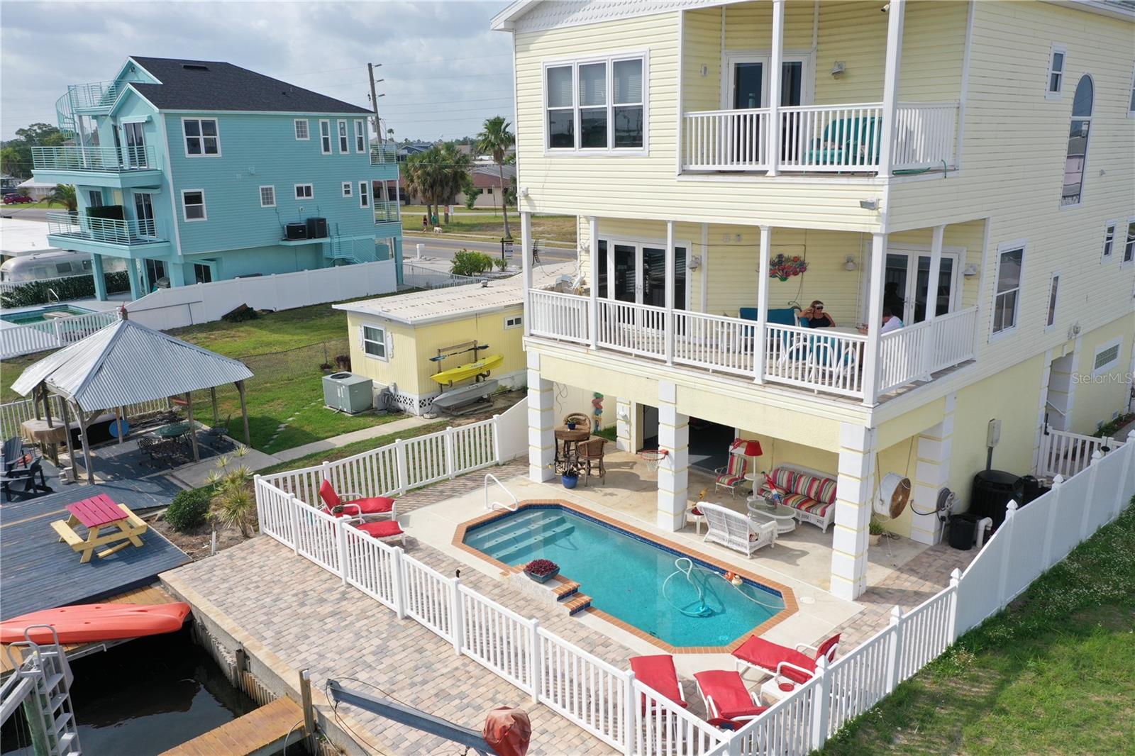 Waterfront & Gulf Access POOL HOME with large Dock with Lift and Gulf Views on deep Canal.  Amazing waterfront views can be seen from 4 large balconies & lots of large windows to soak up gorgeous Florida sunsets.  The large 2nd floor balcony expands the entire length of the 2nd level and has a custom outdoor grill area and extra wide space for tables and chairs with an incredible view.  The dock lift allows you the ability to drop your boat in the water in the DEEPEST, WIDEST canal in this area that leads directly to the gulf. Take your own boat from your dock with lift to catch your next big fishing adventure, take a day with loved ones on the water to nearby private islands or waterfront restaurants with dock access.  Extra bonus is that the sea wall was also just updated and one of the lift motors was just replaced.   There is power and water at the dock with a ladder for floating in the water or taking a kayak to the flats to explore! The pool was resurfaced in 2023 with a spillover waterfall feature surrounded by a paver patio and fenced yard.  The house is 3 levels with a dumbwaiter for helping to carry in groceries to the 2nd level and also a laundry chute from the 3rd to 2nd level and a central vacuum system throughout.  The home features an open floor plan and large kitchen with ALL NEW Appliances that is perfect for entertaining or just to have lots of open space with views of the water from every room.  The Master bedroom has the best views with a private balcony and large bathroom with a step in shower and jacuzzi tub.  The entire interior was recently painted for a very clean, neutral color throughout the home.  Boat lift was replaced in 2020, 2 new AC systems in 2023, New pool pump in 2024 (even have an extra in a box that goes with the sale. Tile and laminate flooring throughout the home (no carpet) with lots of storage spaces.  The garage is a full 3 car garage with high ceilings and lots of storage areas with a 1/2 bath on the bottom level.  On entertaining days, you can open the doors and enjoy the breeze throughout house.   This location is amazing and everyday feels like a Florida vacation with walking distance of Hudson Beach, ice cream shops, beach bars, Marina and the public boat ramp.  You are also 45 min from Tampa Airport for easy access to anywhere and by boat you can go to Clearwater Beach or Honeymoon Island in about 30 min by boat,  This is truly living the Florida Lifestyle!