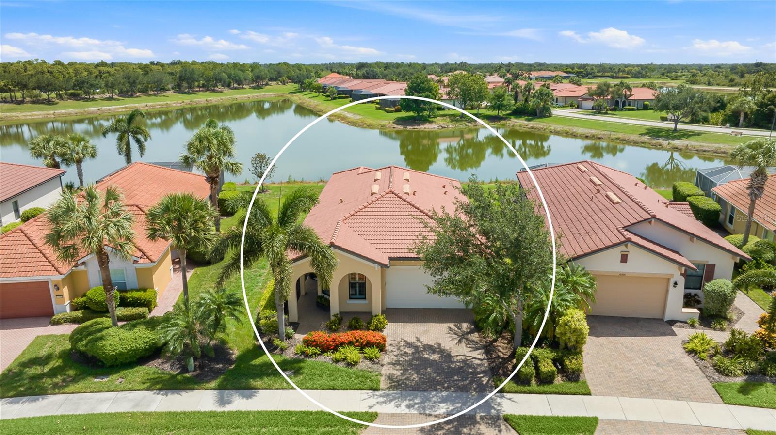 Welcome to Sarasota National, one of Venice's premier resort lifestyle communities, where this lakefront home delivers move-in ready comfort behind a classic Mediterranean facade. A barrel tile roof, paver driveway, arched covered entry, and lush tropical landscaping frame the front of the home, while a wide, sparkling lake view stretches across the back, catching the light from sunrise to sunset. Inside, just under 1,600 square feet lives beautifully, with diagonal-set tile flowing through an open great room layout. The kitchen anchors the space with crisp white cabinetry, granite countertops, a stone tile backsplash, stainless steel appliances, a closet pantry, and a generous island with pendant lighting and seating for casual meals. Graceful archways connect the kitchen to the dining area and laundry room, and the family room opens through sliding glass doors to the lanai, pulling that lake view into everyday life. The owner's suite sits privately at the rear with a walk-in closet and a bath featuring a dual-sink granite vanity and a tiled walk-in shower with decorative listello accent. At the front of the home, the second bedroom enjoys dual windows and sits steps from a full guest bath. This home has been meticulously cared for. The A/C was replaced just one year ago, the water heater about two years ago, and the plumbing has been redone in the bathrooms, kitchen, and laundry. Additional upgrades include a Culligan reverse osmosis water filtration system, plantation shutters across the front of the home, hurricane shutters, added gutters and roof vents, and tile grout professionally cleaned and sealed throughout. Out back, the screened lanai offers a paver deck and ceiling fan, an ideal perch for morning coffee or evening breezes over the water. Beyond your door, Sarasota National spans 2,400 gated acres within an Audubon Bird Sanctuary, and the HOA covers lawn care, cable, internet, trash, and full access to the Palm Club, a 32,000 square foot amenity campus with a resort pool featuring lap lanes, spa, and beach entry, a poolside tiki bar, full-service dining with bar and lounge, a state-of-the-art fitness center with group classes and spa treatment rooms, plus tennis, pickleball, bocce, an event lawn, and a dog park. This home sits on the amenity side of the community, so there are no required golf dues, while the 18-hole championship course remains available to enjoy. From here you are minutes to historic downtown Venice, the shops and restaurants of Wellen Park, Braves spring training at CoolToday Park, and the Gulf beaches that define this stretch of coast. Come experience the view, the community, and the ease of living here for yourself. **THIS PROPERTY QUALIFIES FOR A 1% LENDER INCENTIVE IF USING PREFERRED LENDER. INQUIRE FOR MORE DETAILS.**