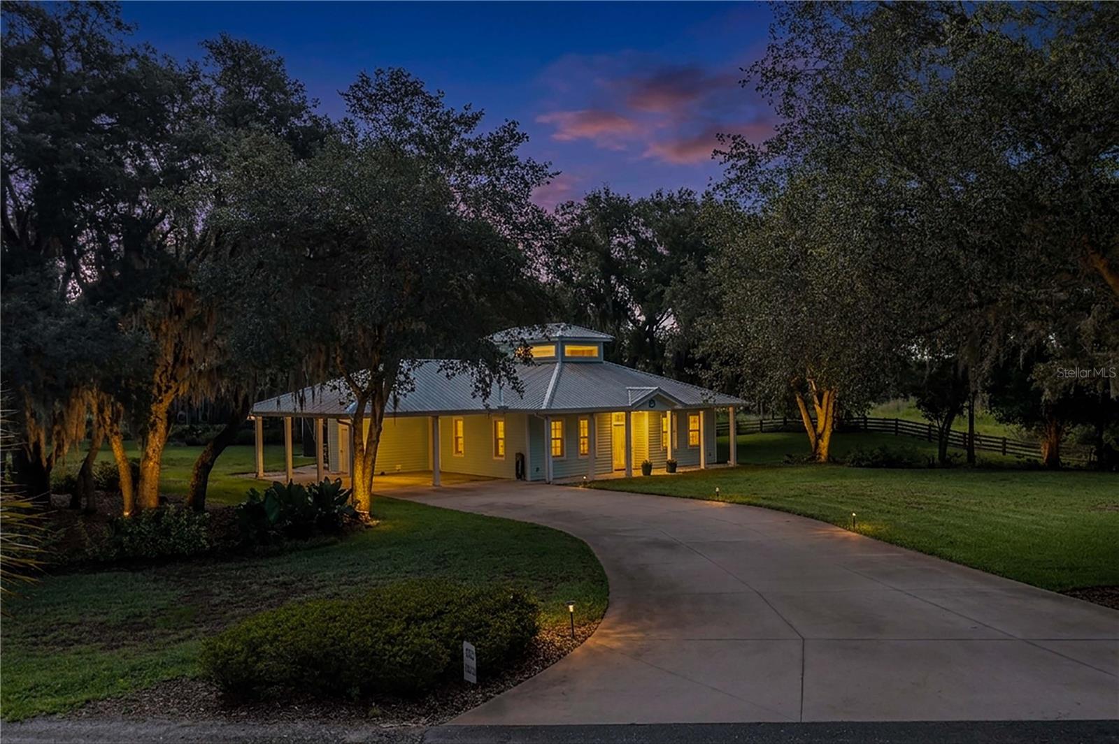 Experience refined country living on 6.36 picturesque acres in beautiful Lake Wales! Surrounded by majestic oak trees and beautiful landscaping, this distinctive property offers privacy and tranquility while remaining conveniently close to town. Pasture areas provide room for horses, cattle, and other farm animals.

Enter through country-style glass doors into an impressive open floor plan featuring travertine flooring, soaring cathedral ceilings, abundant natural light, and a decorative windowed cupola. The beautifully appointed kitchen features granite countertops, stainless steel appliances, gas range, farmhouse sink, additional island prep sink, built-in microwave, dishwasher, and generous cabinetry. The spacious laundry area offers a built-in sink, granite countertops, abundant cabinetry, and space ideal for a coffee bar.

The primary suite features a beautifully designed bath with granite countertops, dual sinks, additional vanity, tiled walk-in shower, private water closet, linen closet, and expansive walk-in closet with custom cabinetry. The second bedroom offers scenic views and double closets, while the guest bath features a granite vanity and walk-in shower.

Enjoy exceptional outdoor living with an illuminated saltwater pool, fire pit, majestic oaks, and automatic low-voltage LED landscape lighting. Starlink high-speed internet provides modern connectivity.

A separate driveway leads to an impressive workshop featuring three roll-up doors, full kitchen with gas range and sink, bar area, recessed lighting, bathroom with walk-in shower, additional storage, and an expansive upstairs storage area. Two additional outbuildings provide even more versatility.

A rare opportunity where luxury, acreage, versatility, and the freedom of country living come together!