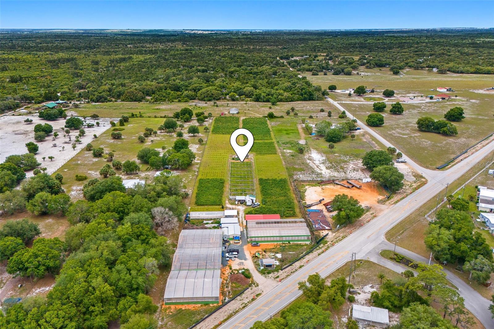 Rare 5-acre previously certified organic farm opportunity in the Lake Wales area featuring extensive infrastructure, established crop production, and exceptional expansion potential. A major highlight of the property is the newly built 2026 five (5) Controlled Environment Agriculture (CEA) greenhouse structures currently reported to be approximately 85% complete, utilizing Nutrient Film Technique (NFT) and Deep Water Culture (DWC) hydroponic systems widely used for high-yield, year-round production. At full capacity, the hydroponic expansion is designed to support approximately 65,000 plants, creating immediate functionality with substantial future production upside.

The existing farm features a diversified portfolio of organically maintained specialty crops, many of which are processed into premium teas, creating a value-added revenue stream aligned with the growing health and wellness market. Current plant inventory includes approximately 30,000 Insulina plants, 8,000 blueberry plants with annual fruit harvests and crop insurance, 600 Fig trees, 600 Passion Fruit plants, and 250 Moringa trees. Total plant count is approximately 39,450 plants, all figures approximate.

The farm is exceptionally well-equipped with 9 wells onsite, a zoned irrigation system, and approximately 18,000 feet of PVC piping rated at 550 PSI. Additional utility improvements include a 10x10 pumphouse, 15 HP pump system, 16KW Generac generator, and 550-gallon propane tank.

Improvements include an 18x30 processing/wine room on slab with air conditioning, 80x20 washing and drying greenhouse, multiple existing greenhouses, storage buildings, support structures, and a 20x60 open metal building. Existing infrastructure represents a substantial investment and may significantly reduce startup costs, time, and development risk for growers, investors, operators, or agribusiness entrepreneurs seeking an active agricultural footprint with expansion potential.

Strategically located near Highway 60 with strong access to Orlando, Tampa, and markets throughout Central and South Florida. A rare opportunity to acquire established agricultural acreage with infrastructure, hydroponic expansion, production capacity, and future upside.

Previously certified organic farm; new owner may have the opportunity to reapply for organic certification subject to applicable requirements and approval.

Lot dimensions approximate; buyer to verify. All measurements, crop counts, acreage, certifications, construction status, equipment, improvements, and property details are believed to be accurate but should be independently verified by Buyer. Any information regarding agricultural operations, production capacity, business use, or income potential is not guaranteed.