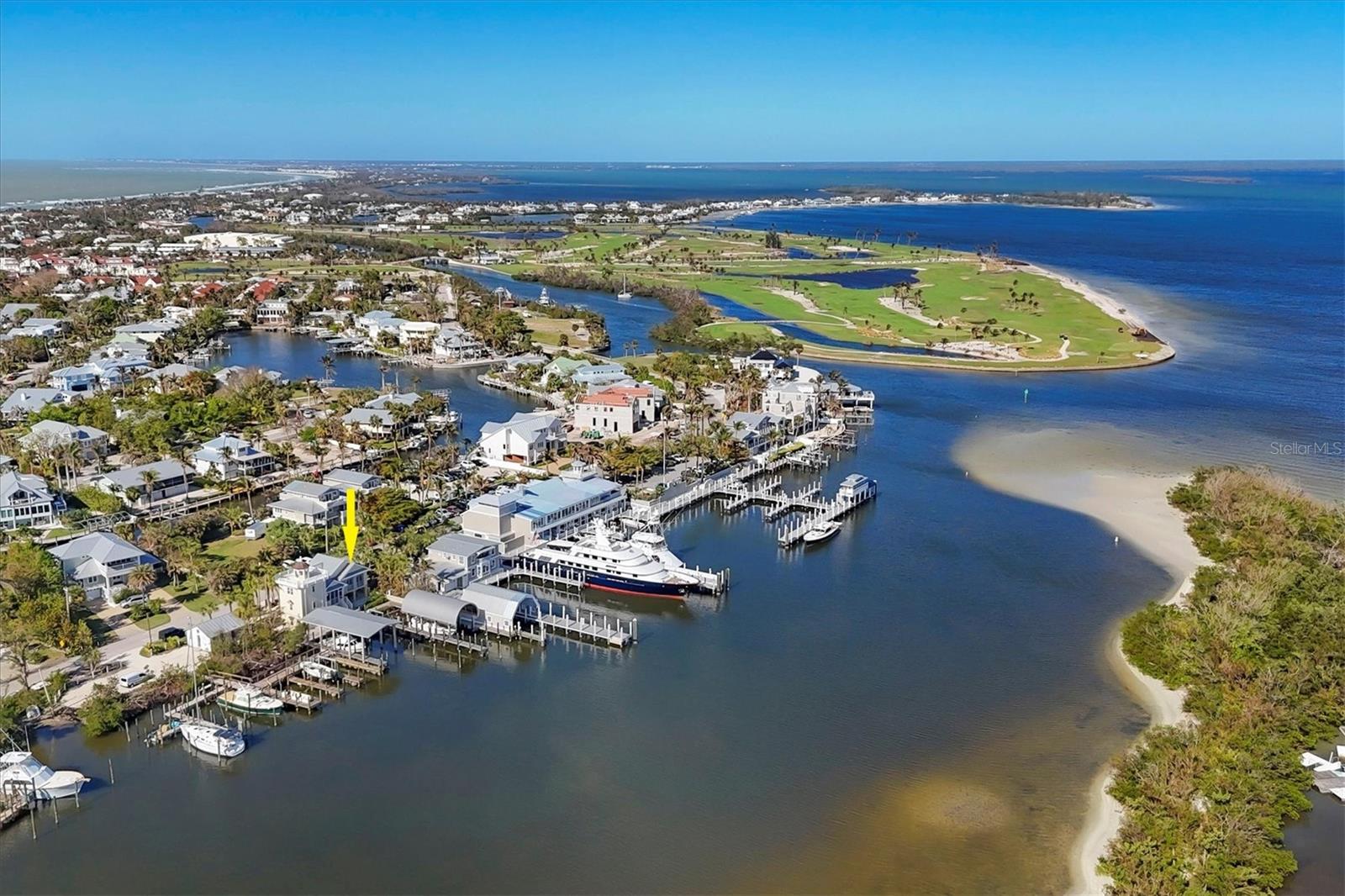 RARE OPPORTUNITY OF PURCHASING A CUSTOM WATERFRONT HOME WITH PRIVATE “MARINA” WHICH INCLUDES 3 DEEPWATER SLIPS, 2 OF WHICH ARE UP TO 100 FEET IN LENGTH, IN THE HEART OF BOCA GRANDE!
Located with easy access to the ICW from the Millers Marina Channel this is a one of a kind property. Offering deepwater, long slip lengths and housing for the owner and/or the crew! Of the two covered slips, one is 60ft x 18 1/2ft and the other slip is 100ft x 18 1/2ft. Both boat covers are a work of art and engineered with concrete 45 ft long driven pilings, metal roof detailed with a yellow pine underside and galvanized aluminum. The center slip is 100ft x 20ft and is equipped with a lift. A tackle room is conveniently located adjacent to the dock for easy access.  
Designed by architect George Palermo and built by Pat Ball of Ball Construction originally on a 50 ft wide lot in 1994 then added on in 1999 when a 25ft adjacent lot was purchased for a combined 75ft of prime waterfront.  The home consists of 4 bedrooms, 4.5 baths, a comfortable kitchen and living area, loft, large screened deck overlooking the water and boat docks plus a roof top deck. The house can be used as a primary or vacation home as well as staff for crew and team members. The main house has a kitchen and living area with sliders and a screened lanai overlooking the water and docks. The master bedroom has a queen bed and an en suite bathroom with a stall shower. There is also a guest bedroom with a queen-sized bed, both bedrooms have sliders to enjoy the view, with electric hurricane shutters for extra protection. A loft area overlooks the living area and water with a trundle bed but is also perfect for an office!  The “Lighthouse” is accessed via a rear entrance to a bedroom with an en suite full bath, then up a set of stairs to a loft with built-in bunk beds and a full bath. There is a special rooftop deck with a custom copper topped light with access via pull down stairs. Call now for a private showing of this special piece of Boca Grande, Florida.