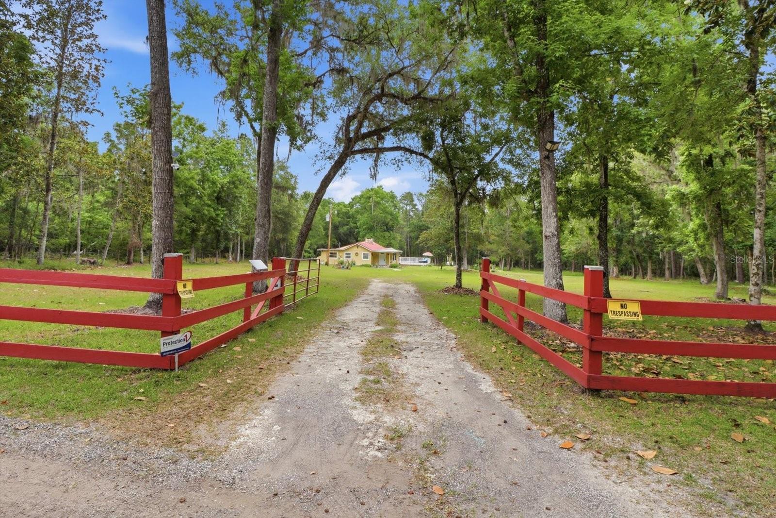 One or more photo(s) has been virtually staged. What a unique opportunity to own a homestead with the perfect blend of privacy, natural beauty, convenience and the ability to be self-sustaining, with this move in ready, super comfortable 2BR/1BA single family home on 4.80 acres at the end of a quiet, paved road in Brooksville, Florida. Enjoy exceptional seclusion with two sides of the property — to the north and east — bordering a vast conservation area (Chinsegut) filled with trails to explore.  Property is zoned AR, allowing for livestock as well.
This 1,246 sq ft home has been thoughtfully updated throughout, including a brand-new home foundation and brand-new subfloor, both completed by licensed professionals and backed by transferable warranties. Inside, new laminate flooring and deluxe baseboards create a clean, modern finish that pairs beautifully with the fully renovated bathroom, electrical updates, and the cozy wood burning fireplace with a stone mantel, hearth and chimney.
Outdoor living shines here with a new 36' x 28' composite deck featuring a built in 8.5' x 12.5' spa with secure railing — perfect for entertaining or unwinding under the stars. A 12' x 24' shed with electricity and water offers ideal space for storage, hobbies, or workshop use. The property is fully fenced with motion sensor and solar lighting throughout.
The 4.80 acres are mostly cleared and dotted with oak, pine, and cedar trees, along with an impressive variety of fruit trees including orange, fig, papaya, peach, persimmon, olive, Meyer lemon, guava, cherry, and yucca. Wildlife sightings are common, adding to the peaceful, natural setting.
The sale includes all kitchen appliances, featuring a brand-new large side by side refrigerator, plus a washer, dryer, and water softener. Additional recent upgrades include a 2021 tin roof, new gutters, four mini split AC units (installed 2021) with room to add another unit, a one-year-old well, and a septic system inspected in the last three (3) months. A new automatic entrance gate opener has also been added.
Seller is open to negotiating the purchase of lawn/property equipment, if desired. Located less than six miles from major conveniences, this property offers a rare opportunity to enjoy peaceful country living while staying just minutes from everyday essentials.
Come see this gem before it is gone!!