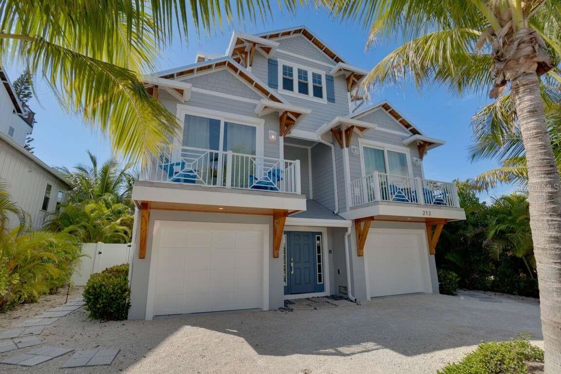 Newly renovated - Stunning 4-bedroom, 6.5-bath is perfect for beach lovers just a block from the Gulf of Mexico beaches. This island home features a backyard with a private pool and tiki bar, hot tub, BBQ area, covered patio with a foosball table, and a rooftop deck with water views. The main living space, includes a kitchen with a beautiful backsplash and quartz countertops, solid wood cabinets, island seating, couches, and a bright dining room with access to a covered deck overlooking the pool. The third floor hosts the primary bedroom, a private balcony with rooftop deck access, and an ensuite bathroom with a double vanity and a large shower. Outdoor amenities also include a pool, spa, This home is just a quick walk to the beach, and guests can easily take the trolley to Pine Ave for local delicacies, fish at the historic AMI city pier, or kayak in the bay waters.