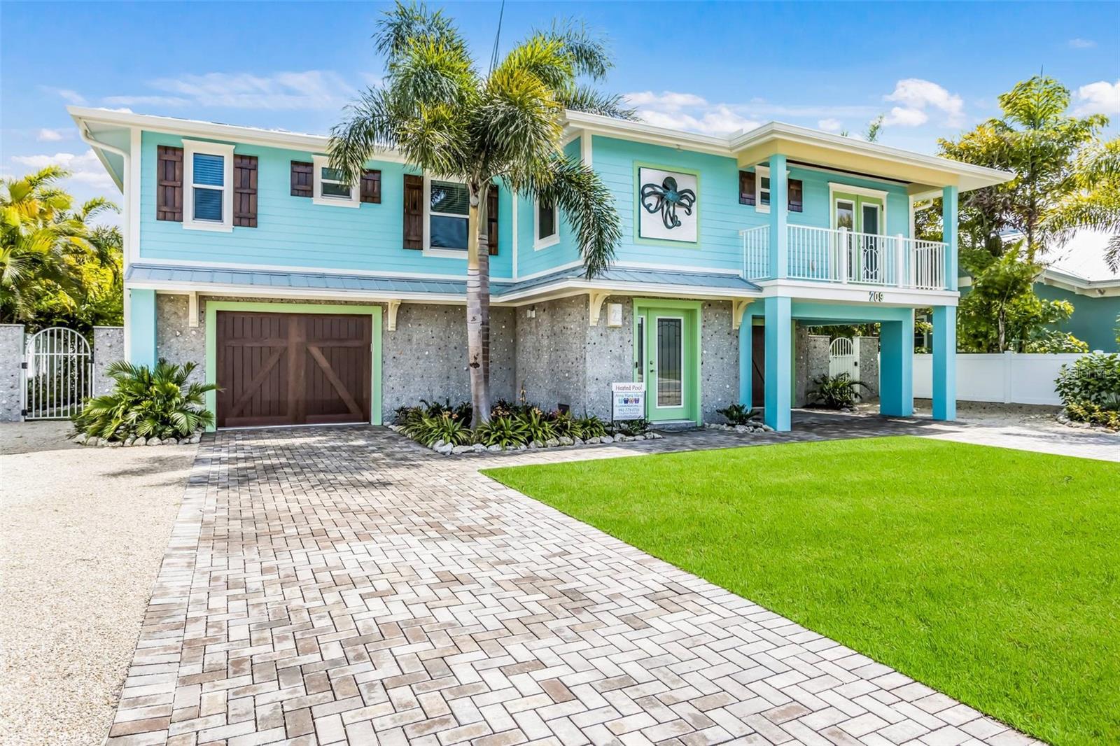 Welcome to Octopus Cottage, a stunning 4 bedroom/4.5 bath home, ideally situated just one and a half blocks from the pristine Gulf shores of Anna Maria Island. Embrace the epitome of coastal living with this meticulously designed home boasting an open floor plan, perfect for hosting memorable gatherings.
Step into the expansive kitchen, outfitted with top-of-the-line stainless-steel appliances, where culinary delights are effortlessly prepared. Adjacent to the kitchen, a beverage bar awaits, complete with a wine cooler, catering to every hosting need. As your loved ones gather around the elegant eight-top dining table beneath a captivating seashell chandelier, indulge in the joy of shared meals and laughter.
Discover unparalleled comfort in the four bedrooms, each offering luxurious ensuite baths. The main master suite beckons with its lavish ensuite bath featuring a separate tub and shower, double sink vanity adorned with artistically framed mirrors, and a spacious walk-in closet. French doors lead to the balcony, offering a serene retreat to unwind and soak in the island ambiance.
Outside, a heated pool awaits, featuring a swim-up table and a rejuvenating hot tub. The poolside oasis beckons with an oversized covered lounge area, complete with a lively bar, dart board, ping pong table, cornhole, firepit, and a large outdoor TV, ensuring endless entertainment for all.
Ascend to the balcony, where a wet bar with a built-in grill awaits, promising unforgettable al fresco dining experiences against the backdrop of breathtaking sunsets. Immerse yourself in the refreshing beach-chic décor that permeates every corner, highlighted by custom art, furnishings, and fixtures, including a charming driftwood banister and a mesmerizing glass bubble chandelier.  This home is being sold turnkey furnished.
Experience the convenience of exploring Anna Maria Island's enchanting charms with ease, thanks to the Island Trolley accessible from nearby stops. Indulge in the myriad of culinary delights, boutique shops, and marinas scattered across the island, promising endless adventures for all ages.  Whether seeking a family beach retreat or an investment property with lucrative rental potential, Octopus Cottage embodies the essence of island living at its finest. Don't miss the opportunity to make this exquisite haven yours. Schedule an appointment today to witness the unparalleled beauty of this coastal gem.