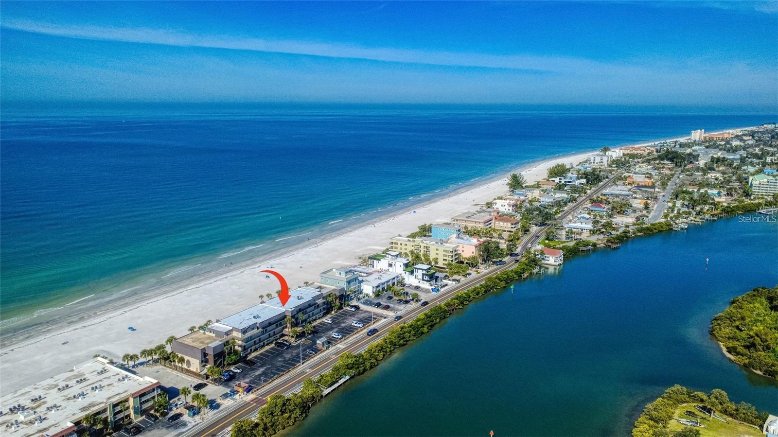 Direct beachfront condominium offering a minimum weekly lease period and unobstructed panoramic views of the Gulf on Indian Rocks Beach. Located on the quiet southern end of the building, this unit provides added privacy with no units above and separation from the pool area—an attractive feature for both owners and renters. Situated in the highly desirable Indian Rocks Beach, a location known for limited inventory and consistent rental demand. The Gulf and white sandy beach are just steps from the unit, while the Intracoastal Waterway and community dock are located directly across the street, visible from the guest bedroom and adding to the property’s broad rental appeal. This townhome-style condominium within a 34-unit complex is being sold fully furnished and turnkey, allowing a new owner to step in and begin generating income immediately. The functional layout is well suited for short-term rentals, with the main living level featuring the living and dining areas, a fully equipped kitchen, and a full bathroom. Two bedrooms with generous closet space and an additional full bath provide privacy and flexibility for guest stays. The unit offers a proven rental track record and is well positioned for continued income production due to its beachfront setting, efficient design, and renter-friendly amenities. Community features include a large heated pool with a grilling area, enhancing guest appeal. Numerous nearby restaurants further support strong rental demand and convenience. High-speed, private internet is included in the condo fee, and smart TVs are installed in the living room and both bedrooms—ideal for today’s short-term rental expectations. The kitchen is fully stocked for extended stays, and beachgoers appreciate the included chairs, umbrellas, towels, cooler, and beach accessories, reinforcing the unit’s true turnkey readiness. Sleeping accommodations include a king bed in the primary bedroom and two queen beds in the guest bedroom, accommodating a wide range of rental groups. The condo is well maintained, move-in ready, and positioned for immediate occupancy or continued rental use. A dedicated parking  space is located directly below the unit, with convenient access via stairs or elevator. Additional guest parking is also available. On-site resident managers provide oversight and day-to-day support, adding value for investors seeking a hands-off ownership experience. Easy access to St. Petersburg and Tampa expands the visitor base with nearby attractions, dining, shopping, and entertainment. Indian Rocks Beach remains a high-demand short-term rental market, making this property an excellent opportunity for investors seeking a fully furnished, turnkey, beachfront income-producing asset.