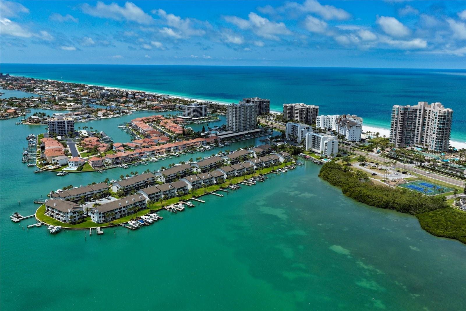Reduced $26,0000-Exceptional Value!!! Live the ultimate Florida lifestyle in this spacious waterfront townhome with sweeping open water views of the Intracoastal and Clearwater Harbor.  Start your mornings watching dolphins glide by from your private waterfront terrace and end your evenings with spectacular sunsets dancing across the water. Whether cruising to waterfront restaurants, spending the day on the Gulf, or enjoying quiet moments surrounded by native birds and tropical breezes, every day feels like a vacation. 
For boating enthusiasts, the property features a newer TREX dock with water and electricity along with a 16,000-lb boat lift, offering easy access to the Intracoastal and Gulf of Mexico. 
 The spacious layout includes two ensuite bedrooms upstairs, along with one on the first level with direct access to the water.  Spacious living areas, a two car garage, and a cozy gas fireplace for the rare cool Florida evenings. Luxury vinyl flooring in the primary and guest bedrooms adds both style and practicality for coastal living. 
This pet friendly community offers a stellar location-steps from the heated pool and private beach access, and minutes from shopping, dining, and all the amenities of Clearwater Beach. Perfect for a primary residence or a low maintenance second home, this townhome at Marina Del Rey is a private waterfront escape where boating, nature, and luxury come together every single day.