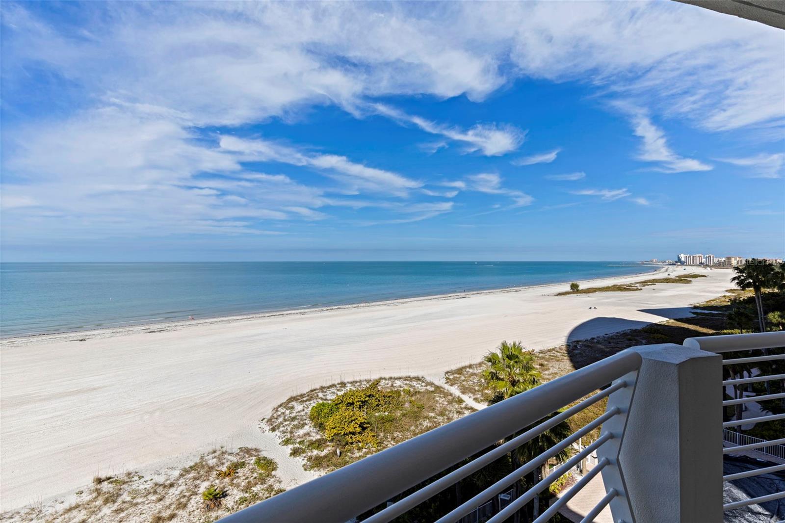 Spectacular Gulf-front end-unit condo in the luxury boutique mid-rise complex of Utopia. This stunning 3-bedroom, 2.5-bath residence offers abundant natural light and an open-concept floor plan ideal for entertaining. Travertine flooring flows throughout the main living areas, with plush carpet in the bedrooms. Sunshades at all windows and doors provide comfort and privacy without sacrificing the views.  Enjoy outdoor living with four private balconies—two overlooking the Intracoastal and two capturing breathtaking Gulf views—perfect for savoring spectacular sunrises and unforgettable sunsets. The expansive kitchen features painted wood cabinetry, quartz countertops, and a large island seamlessly connecting to the living and dining spaces.  The Gulf-front primary suite is a true retreat, complete with its own private balcony and a spa-inspired ensuite bath featuring a double-sink vanity with granite countertops, a garden tub, and an oversized walk-in shower.  Large walk-in closet.  Both guest bedrooms have private balconies.  Utopia offers a state of the art gym, social room, heated swimming pool, heated spa & grll area.  Situated on Sand Key of famous Clearwater Beach. Miles of pure white sand.  Covered under-building parking adds convenience and peace of mind.  Walk to great restaurants & shops or catch the Beach Trolley right out in front of the building. A short drive to Tampa & the airport plus all of the sports venues of our championship teams & cultural centers.  An exceptional opportunity to own refined coastal living with panoramic water views in one of the area’s most exclusive boutique communities.   Call for your private tour today & START LIVING THE FLORIDA BEACH LIFESTYLE!! See video!