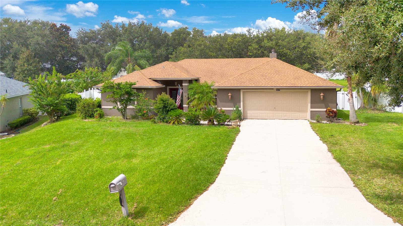 Welcome to your own slice of paradise on nearly half an acre at the top of the hill! As you walk in the double front doors, you will be greeted by beautiful luxury vinyl floors (2020) and vaulted ceilings flanked by an open formal dining room and and living room. Just beyond the half wall, is the heart of the home.  The kitchen is well laid out with plenty of cabinet and counter space and easy access to all of the stainless steel appliances.  The breakfast bar opens up to a dinette and bright family room with wood-burning fireplace!  Take a step through the french doors in the dinette and enjoy the outdoors under the shaded comfort of your extended covered lanai, or venture out into your enormous, fenced-in yard for some outdoor fun!  Back inside, the split floor plan offers plenty of privacy. On one end, you'll find the main bedroom with ensuite with french doors to the lanai. Your private oasis of an en suite includes dual vanities, walk-in shower, and garden tub for soaking. On the other end of the home, you'll find two sizable bedrooms, and an updated guest bathroom (2020). The home also features a newer roof (2018) newer HVAC (2020) and oversized garage for plenty of storage. Don't miss out on this gem, nestled in a small quiet community with low HOA, in the rolling hills of Clermont, FL!