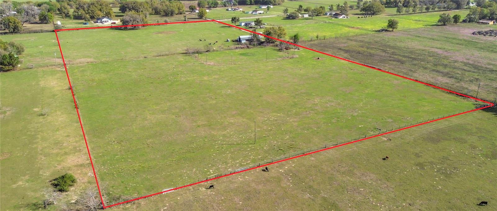 20-Acre Turnkey Farm Property in NE Oxford, FL

Exceptional opportunity to own a fully equipped 20-acre equestrian property in one of Central Florida’s fastest-growing areas. This versatile, income-producing property is ideal for horse enthusiasts, trainers, ranchers, or investors seeking immediate usability and future upside.

The property features a 40' x 72' pole barn with seven 12' x 12' stalls, including three with 20' run-outs, plus ample space for hay, feed, and equipment storage. A 140' x 240' lighted Red River roping arena provides excellent space for training, events, or riding, complemented by a working pen, cow pen, and 50' round pen.

Fully fenced and ready for livestock, the property includes a newer 10" well with a dedicated livestock pump and multiple water stations throughout. The land is currently producing approximately 80 round bales of hay annually, adding agricultural value and potential income.

An existing survey is available, and the property offers the option to divide into two 10-acre parcels for added flexibility or investment potential.

Conveniently located just minutes from I-75 and the Florida Turnpike, shopping, and dining, and approximately 30 minutes to Ocala.