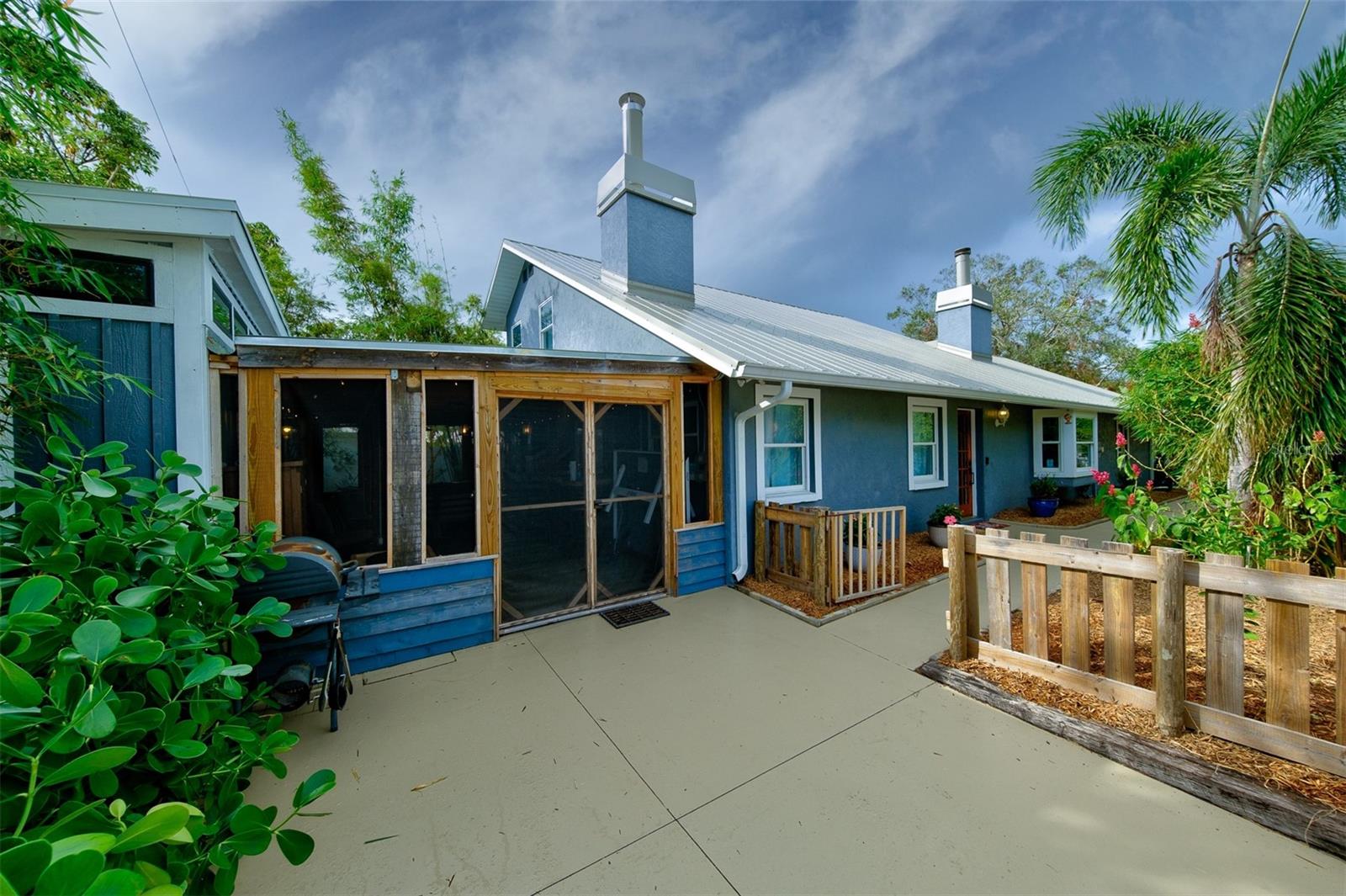 Welcome to a refined corner-lot home directly across from Arlington Park — one of Sarasota's most beloved neighborhood amenities. With 1,955 sqft of thoughtful living space, three bedrooms with walk-in closets, two updated baths, and a true 2-car garage, this property offers a combination that simply doesn't exist at this price point in the heart of the city. Every detail has been considered for Florida living. A 2022 metal roof with a 50-year warranty, two new Trane HVAC systems, impact-resistant windows, and a new water heater mean lower insurance, lower utilities, and no deferred maintenance. Located in evacuation Zone E and high and dry through every recent storm season, this is the rare home that lets you stop worrying about Florida ownership. Inside, character meets quality: stained solid wood doors, crown molding, hardwood bamboo flooring, a maple stairwell, and warm wooden ceilings. Walk out to a generous screened lanai, private hot tub, and lush tropical landscaping framed by palms, bamboo, and fruit trees. The fully fenced yard provides quiet privacy in a setting most Sarasota buyers only dream about. Step out your front door to Arlington Park's 50-meter lap pool, tennis courts, basketball courts, dog park, and walking trails. Sarasota Memorial Hospital, Southside Village dining, and downtown are all within minutes. Beaches at Siesta Key are a short drive away. Zoned for top-rated Southside Elementary (A-rated). A rare opportunity: turnkey, insurable, and irreplaceable location — directly across from the park.