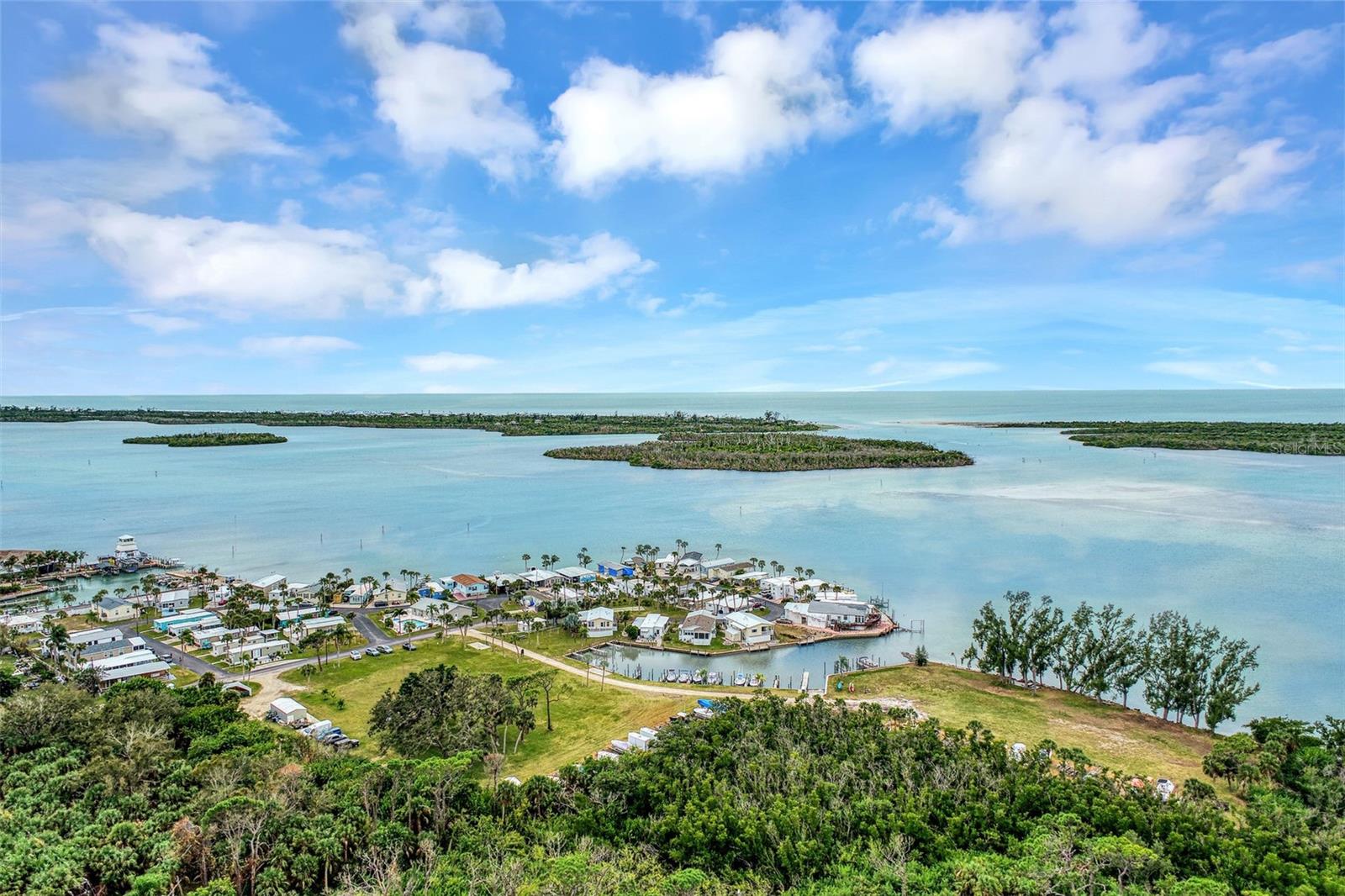 Are you looking to plant roots in an intimate, boater-friendly community where every sunset feels like a private celebration? This is a rare, blank-canvas opportunity to build your dream getaway in a charming, a gated 54-unit mobile home community located directly on the pristine waters of Lemon Bay! Why will you love it here? With rentable boat slips right in your own community’s small marina, and the ability to launch right here, you’ll enjoy every boater’s dream in this part of Florida--seamless access to Stump Pass and the legendary deep-sea fishing on the Gulf of America.  So, no more idle time storing your boat or trailer.  In fact, that’s free here at Stump Pass! No bridges in the way, and sandbars are waiting minutes away to meet your fellow beach and water lovers.  This lot enjoys southern water views. Plus, with a quiet recreational area immediately behind the property, you’ll never have a neighbor behind you. Just steps away from the local favorite Lighthouse Grill & Tiki Bar, you can enjoy bayfront dining, live music, and sunset cocktails. For those with larger vessels, a full-service marina with dry storage is located right next door. Bring a Neighbor—at this time, the lot next door is also available for purchase. This is a perfect setup if you’ve been dreaming of having a family member or best friend live right next door.  After recent storms, this intimate community is evolving. This is your chance to get in on the ground floor of a neighborhood that values resilience, connection, and the laid-back Florida lifestyle. Park Pointe is a deed-restricted, approximately 10-acre neighborhood that only allows manufactured homes, with affordably low association fees. Buyers will own one share of stock in Park Pointe, Inc., a limited corporation cooperative with only 54 stockholders.  No pets allowed.