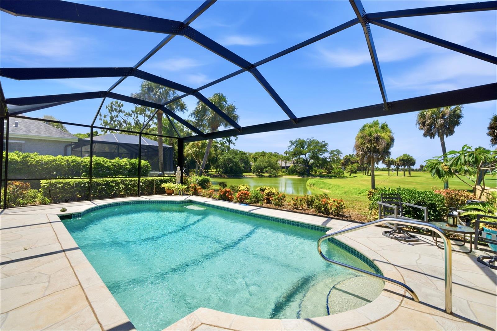 Perfectly positioned along one of Boca Royale's picturesque oak-canopied streets, 51 Golf View Drive offers timeless elegance, exceptional outdoor living, and sweeping views of both the tranquil lake and golf course beyond. A beautifully landscaped setting, enhanced by a paver circular driveway, paver walkways, and a side-entry two-car garage, creates an unforgettable first impression with outstanding curb appeal.

Inside, this thoughtfully designed three-bedroom, two-and-a-half-bath residence encompasses 1,840 square feet of inviting living space highlighted by soaring ceilings, tray ceiling details, crown molding, and an abundance of natural light. The spacious primary suite provides a peaceful retreat with an updated ensuite bath featuring dual vanities, a walk-in shower, and refined finishes, while the guest bathrooms have also been tastefully renovated.

The true centerpiece of the home is the expansive outdoor living area. Enjoy a coveted southern exposure from the oversized screened lanai, where a sparkling pool, covered entertaining area with ceiling fans, and panoramic clear-view screen enclosure create the perfect setting to relax or entertain while taking in long lake and golf course vistas. Mature tropical landscaping provides beauty and privacy, seamlessly blending the home with its natural surroundings.

Ownership includes a Social Membership to Boca Royale, allowing residents to enjoy an exceptional lifestyle with a beautiful clubhouse, full-service restaurant and bar, fitness center, tennis and pickleball courts, and a vibrant calendar of social events and activities. Whether you're seeking a year-round residence or a seasonal Florida retreat, 51 Golf View Drive offers an outstanding combination of comfort, quality, and resort-style living within one of Englewood's most sought-after gated communities.