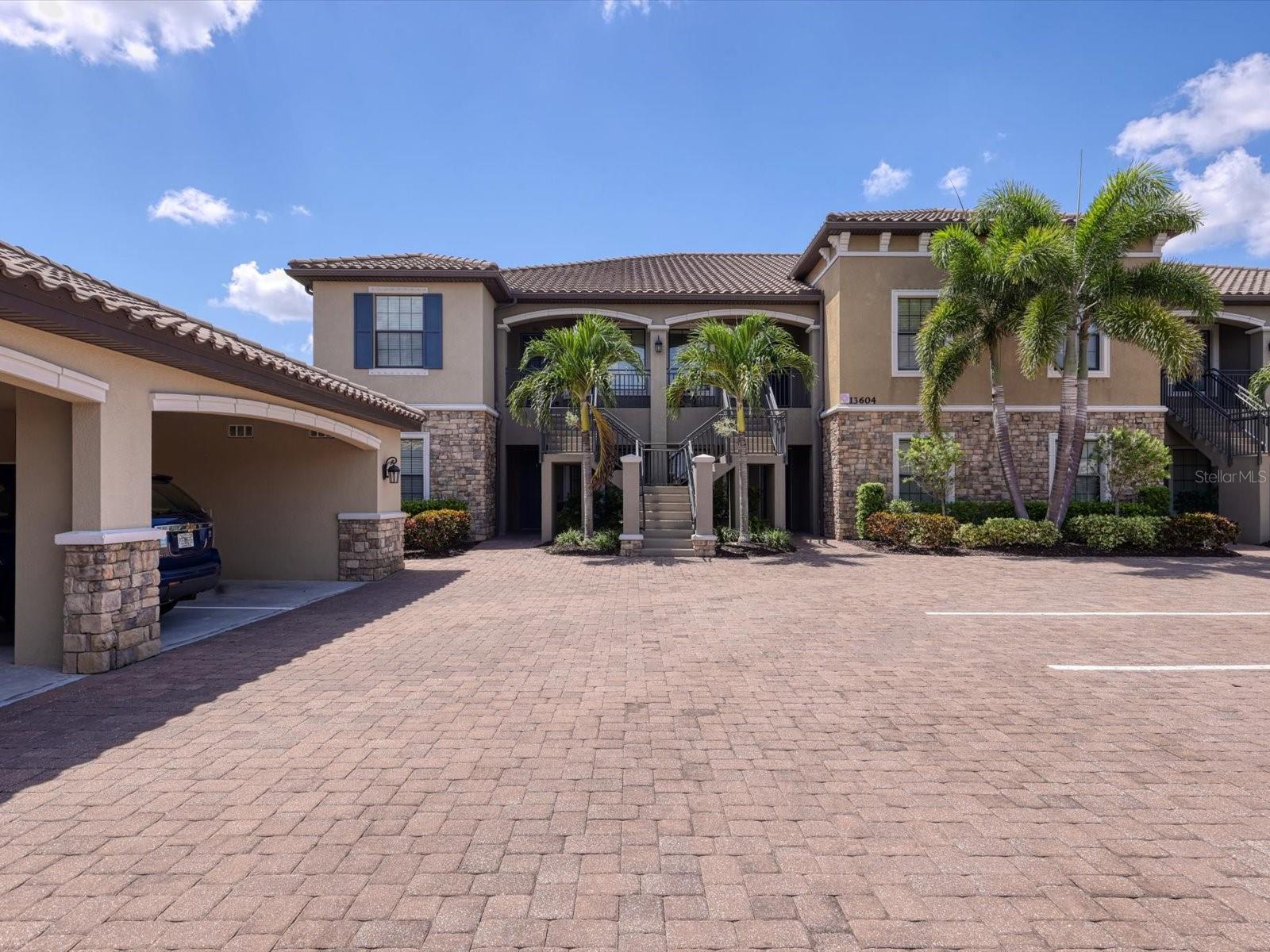 Unfurnished Annual Rental Available Now. This beautiful first floor 2/2 plus den end unit is flooded with natural light. This unit features an tropical view. Spacious kitchen with white cabinetry, granite, and stainless-steel appliances. There is an eating space in the kitchen, breakfast bar, and pantry. The kitchen is open to the dining room and living room. There is also a den for extra space. The master suite has two walk-in closets, and double sinks, and stand-up shower. There is a covered parking space as well as guest parking. Esplanade Golf and Country Club is known for its resort lifestyle in the heart of Lakewood Ranch. This gated enclave is spread out over 600 acres. You will find a new club house with huge resort style heated lagoon pool and spa, with private cabanas, a 16,000 foot Culinary Center featuring a full service restaurant and TIKI bar, and wine tasting room, top of the line fitness center with locker room, tennis club, full service spa offering massage therapy, hair and nails, fitness classes, Wellness Center, bocce ball courts, pickleball and BBQ grills with outdoor dining options and championship 18 hole golf course, and this property comes with a Golf Membership. Only a short distance to Lakewood Main Street shopping, restaurants, and cinema. Convenient to the UTC Mall, shopping, restaurants, entertainment, and Lakewood Ranch Hospital. Easy access to I-75, Sarasota Airport, Tampa International Airport, and Tampa/St. Petersburg. Only Minutes from Nathan Benderson Park with world class rowing events, premier sports fields and world class beaches. Rent Includes Water\Sewer\Trash and Pest Control.