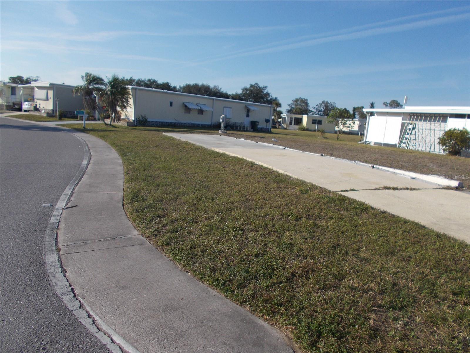 Vacant land in sought after 55+ Gated Community of Holiday Park and in the Pet Section.  This property is located on the corner of Center Lane and Holiday Park Blvd.  This lot is 5,134 square feet and had a double wide mobile home on it.  FOR THE BUYERS CONVENIENCE, THE SELLER HAS LEFT THE DRIVEWAY. In Holiday Park you own the land with a deed and the maintenance fee of $2340.00 a year ($195.00 a month) is included in your taxes.  Holiday Park offers many amenities including 2 Pools, Tennis Courts, Pickle Ball, Bocci, Shuffleboard, Laundry, Library, Horseshoes, Bingo, plus other card games, Fitness Room and so much more.  This home has been pulled off and the electric and water are in place.  This is a perfect place for your new manufactured home.  Come and see!