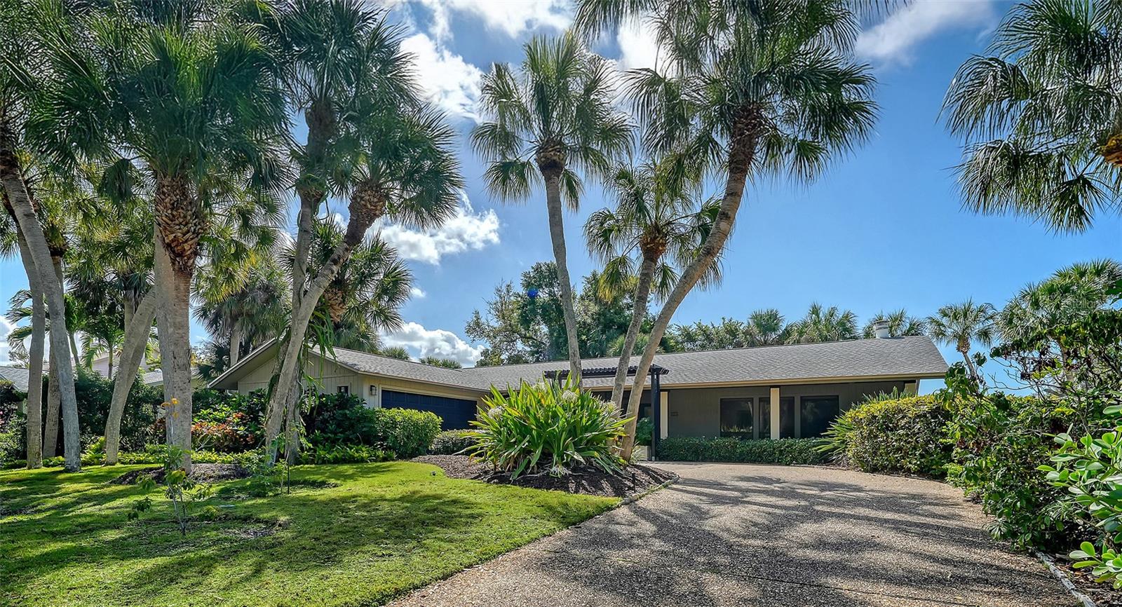 Welcome to Siesta Cove on Siesta Key, just minutes from world famous Siesta Key Beach. This bright, well maintained home offers comfortable island living in one of the area’s most desirable neighborhoods. The layout provides excellent flexibility with both a living room and a separate family room, giving you plenty of space to relax or entertain guests. Oversized windows throughout the home bring in natural light and offer beautiful views of the mature tropical landscaping, creating an inviting atmosphere. Built in cabinetry and shelving add character to the living room, while the two skylights in the family room bring in beautiful natural light throughout the day. The kitchen offers granite countertops, a large island with seating, and generous cabinet storage. The cabinets are real maple with soft close drawers and doors, crown molding, and lighted glass display cabinets. Additional conveniences include under cabinet lighting and pull out drawers, making storage easy and accessible. The primary suite serves as a comfortable private retreat. It features a large walk in closet with built in organization and an en-suite bathroom with dual vanities, granite countertops, and a spacious tiled shower. After spending the day at Siesta Key Beach, you can rinse off at the outdoor shower before heading inside. Two outdoor living areas allow you to enjoy Florida’s coastal climate: a front entrance lanai and a private lanai off the family room, both ideal for morning coffee or relaxing in the evening. The side load two car garage enhances the home’s curb appeal and provides additional storage space. Several major systems have already been updated. The roof was replaced in 2020, including two skylights. The home also features PVC sewer lines, the air conditioning system was replaced in 2022, and the water heater was replaced in 2023. Best of all, the property experienced no damage during the recent storms, providing additional peace of mind for buyers. This is a wonderful opportunity to enjoy the relaxed lifestyle of Siesta Key, just minutes from the beach, dining, and everything the island has to offer.