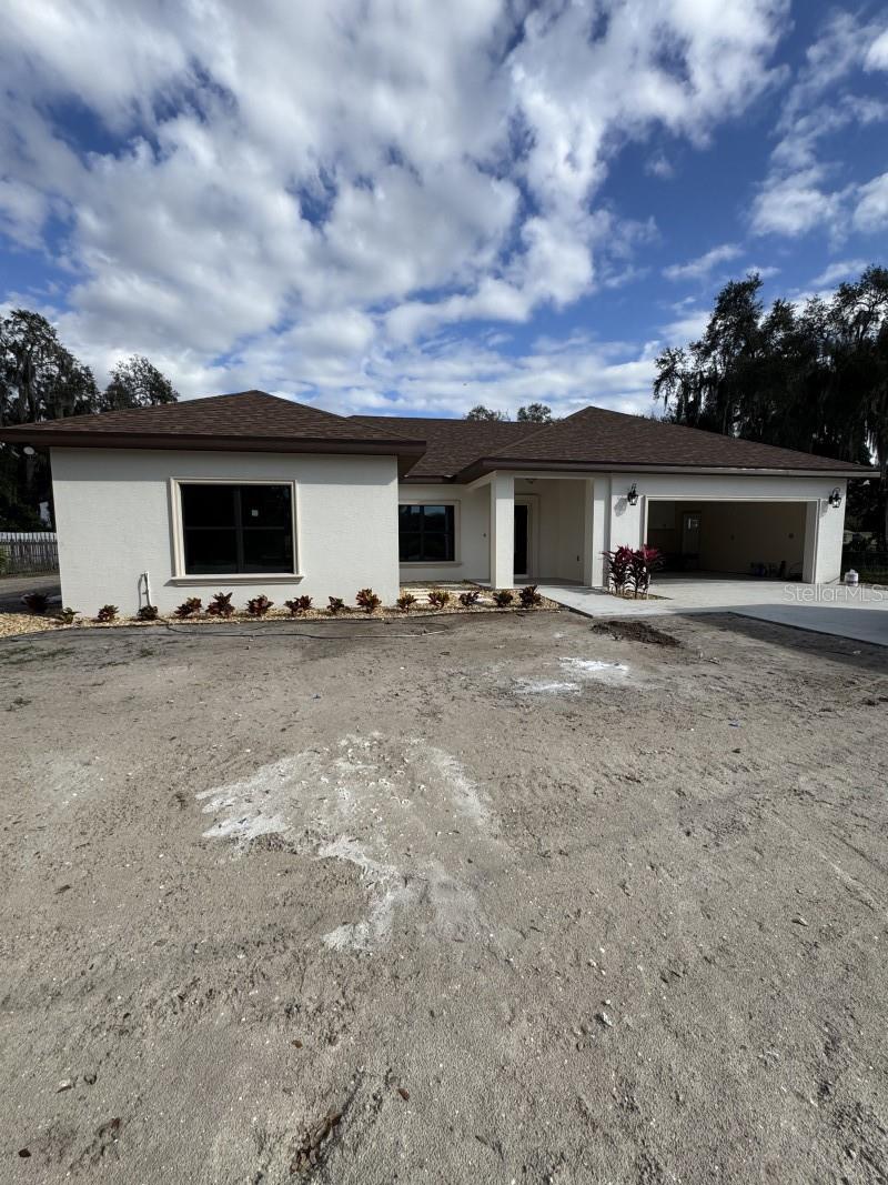 Under Construction. Brand New custom home!!! This home is near completion and available Mid February 2026. Pictures will be updated at completion. Conveniently located close to all the amenities Okeechobee has to offer. This home is not your typical home. This home features 1970 square feet under air, 2,580 square feet total, it is a 4-bedroom 2-bathroom home, the 4th bedroom is nearly the size of the master bedroom!! what makes this home so special? This home features custom finishes not found in your typical home, your typical home has wood baseboards and door moldings, here you will find beautiful CONCRETE 7 1/4" baseboards and 4" decorative concrete door moldings. you won't ever have to worry about water damage to these, you will NOT find this in any other home! it doesn't end there, step outside you will find the same concrete beautiful concrete moldings and windowsills surrounding every window and door, a must see to appreciate! Other features include Granite countertops, a formal dining room, Porcelain tile floors in the bathrooms, living room, and kitchen, with the bedrooms having upgraded carpet. The master bathroom features an oversized walk-in shower AND separate soaking tub beautifully decorated with Tile and concrete mouldings, along with a 2-sink vanity. All closets features beautiful all custom wood shelving, plenty of room for clothes!! The master closet even has a built in safe to protect all your valuables. For your heating and cooling you have a Heat pump system made by Trane. The home features custom impact resistant windows and Doors made by well know window manufacturer PGT. You have beautiful French doors with built in blinds that open up to a beautiful view of the overside back yard, bring your pets, build your pool, there is plenty of space! This home also features and oversized 2 car garage, bring your oversized big truck inside!! Outside you will find the beautiful landscaping and sprinklers to keep your lawn looking beautiful all year long. Some much to list, a must see to appreciate!!!