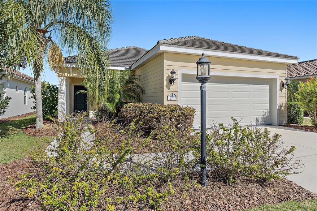 One or more photo(s) has been virtually staged. BETTER THAN NEW AND WAITING FOR YOU! Enjoy this charming MAINTENANCE-FREE home on a premium lakefront lot, only 3 doors down from the "Restort-style" AMENITY CENTER in the #1 MASTER PLANNED Community in the USA! *NO CDD *LOW HOA *WHOLE-HOUSE GENERATOR *WHOLE-HOUSEWATER SOFTENER *WATER VIEWS and ready for IMMEDIATE OCCUPANCY! IMMACULATE 3bed/2bath with OFFICE and EXTENDED WATERFRONT LANAI. This fantastic layout will complement any lifestyle! Off the great room, elegant French doors lead into the WOOD FLOOR office. An inviting kitchen with elevated features like *WOOD CABINETS *GRANITE COUNTERTOPS *GAS STOVE and *SLIDING DOORS (provide countless entertainment options). Stay safe with ROLL-DOWN HURRICANE SHUTTERS on the lanai. The Master bedroom enjoys direct entry into the lanai with a WALK-IN CLOSET and a spacious bathroom. Relish in the benefits of a GAS HOME and INCLUDED LAWN MAINTENANCE using RECLAIMED WATER, which will save on your water bill. Indigo's amenities include a heated pool and spa, a 24/7 fitness center with yoga room, pickleball courts, bocce ball courts, and a full-time lifestyle director. Lakewood Ranch has something for everyone with over ~150 miles of walking/bike trails, parks, playgrounds, over 85 restaurants within 20 minutes, shopping, dining, "A+ rated" schools, and world-famous beaches. Start living the Florida life now!
