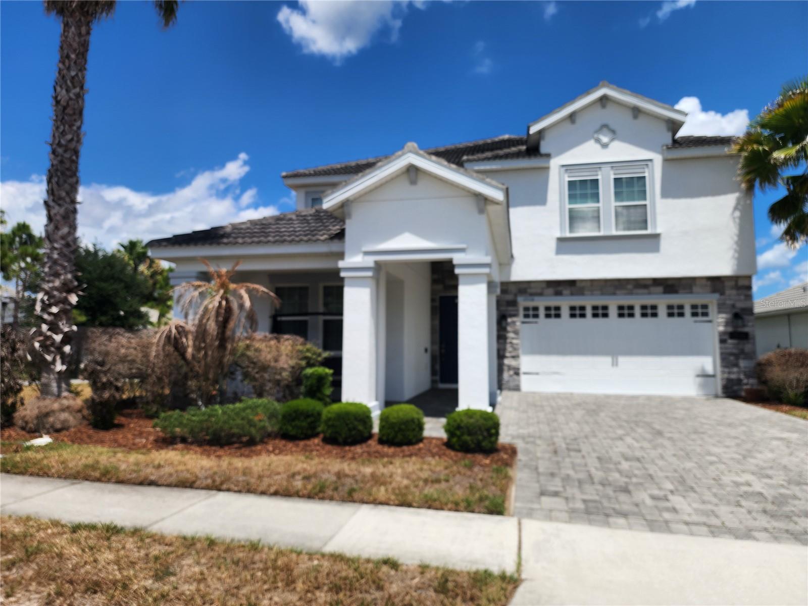 Welcome to this meticulously maintained 5-bedroom, 3-bath home on a premium corner lot in the exclusive 24/7 guard-gated ChampionsGate Country Club community. With just one owner who rarely lived in the home, it shows like new and is ready for its next occupants.

The bright, open-concept floor plan features granite countertops, stainless steel appliances, and a spacious kitchen that flows seamlessly into the main living area—perfect for everyday living and entertaining. Enjoy Florida's beautiful weather from the screened, covered lanai with added privacy. A first-floor bedroom and full bath provide the ideal space for guests, multigenerational living, or a private home office.

As a resident of ChampionsGate Country Club, you'll enjoy access to three outstanding amenity centers. The Oasis Club features a 14,000-square-foot clubhouse with a restaurant, movie theater, fitness center, tiki bar, lazy river, cabanas, and resort-style pool. The Plaza, exclusive to residents, offers another restaurant and bar, two resort-style pools, pickleball courts, a fitness center, and game room. The Retreat Club includes an exciting water park along with additional dining options. Unlike many nearby communities, ChampionsGate Country Club is primarily owner-occupied, providing a peaceful residential atmosphere rather than a transient vacation rental environment.

Lawn care, cable, internet, and security monitoring are included, allowing you to enjoy a low-maintenance lifestyle. Conveniently located just minutes from world-famous theme parks, championship golf courses, shopping, restaurants, and major highways, this exceptional home offers the perfect combination of luxury, comfort, and convenience.

Schedule your private showing today and experience resort-style living every day.