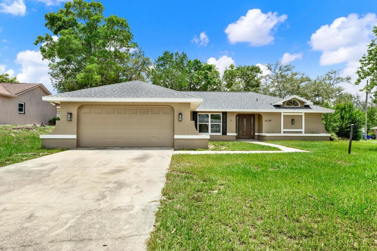 Welcome to this beautifully remodeled 3-bedroom, 2-bath home in Spring Hill, Florida, where modern upgrades, move-in-ready convenience, and an ideal location come together. Situated on a desirable corner lot in the heart of Hernando County, this home offers 1,778 square feet of living space, a spacious 2-car garage, and the peace of mind that comes with a brand-new roof installed in July 2026.
Step inside to discover an open, inviting floor plan highlighted by luxury plank vinyl flooring throughout—no carpet anywhere. The completely updated kitchen serves as the centerpiece of the home, featuring stunning quartz countertops, an oversized quartz island, stainless steel appliances, abundant cabinet space, and the perfect layout for entertaining family and friends. The spacious primary suite offers a relaxing retreat with an updated ensuite bath, while both bathrooms have been tastefully renovated with elegant granite countertops and contemporary finishes. Every room has been thoughtfully refreshed, allowing you to move in without the expense or hassle of future renovations. Outside, the corner lot provides extra privacy, additional yard space, and attractive curb appeal. The oversized garage offers room for vehicles, tools, and storage, making this property ideal for homeowners seeking both comfort and functionality. Conveniently located near Weeki Wachee Springs, the Suncoast Parkway, shopping, restaurants, medical facilities, parks, and Florida's beautiful Gulf Coast, this home offers easy access to everything that makes Spring Hill one of the Nature Coast's most desirable communities.