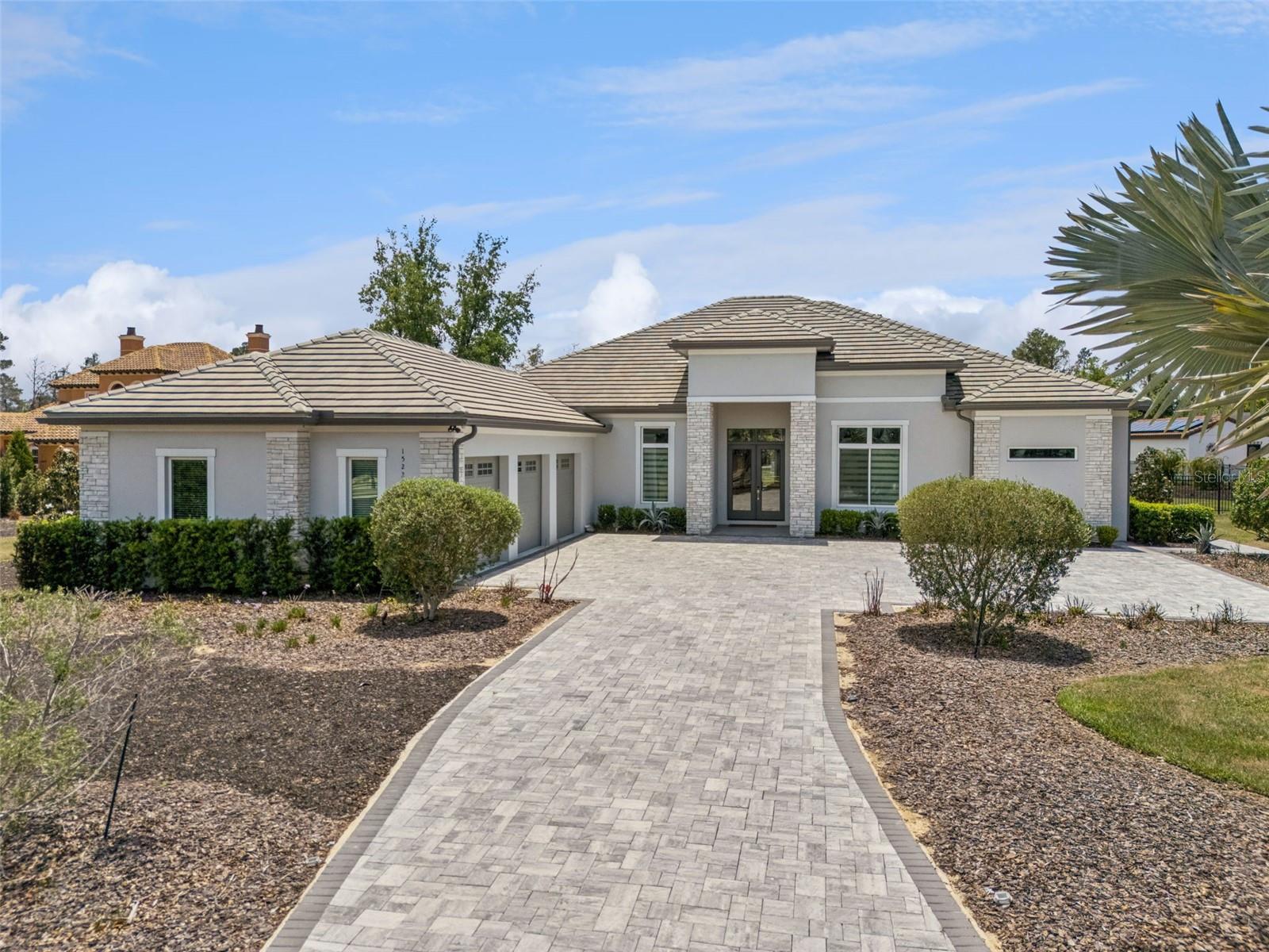 Experience refined single-story living in this exceptional custom estate by Vogel Building Group, ideally situated on an expansive preserve homesite within the guard-gated community of Bella Collina. With no rear neighbors and a deep, private backyard, this property offers a rare combination of space, privacy, and thoughtfully designed indoor-outdoor living.

A grand entry opens to expansive living spaces defined by soaring ceilings, architectural detailing, and walls of glass that flood the home with natural light. The dining area is defined by striking mitered corner glass doors, creating a dramatic frameless opening, while pocketing sliding glass doors in the great room fully disappear to deliver a true indoor-outdoor living experience.

The chef’s kitchen is both striking and functional, featuring an oversized waterfall island, custom cabinetry, designer lighting, and a full suite of professional-grade Thermador appliances. A hidden walk-in pantry enhances both convenience and clean design.

The private primary suite offers a peaceful retreat with preserve views, a spacious layout, and a spa-inspired bath complete with dual vanities, a freestanding soaking tub, and an oversized walk-in shower.

Step outside to a resort-style lanai, where a custom pool and spa anchor the outdoor living experience. The covered lanai and summer kitchen create the perfect setting for year-round entertaining, while the expansive backyard extends to a dedicated firepit area and a private putting green, offering a rare blend of relaxation and recreation.

Set on a generously sized homesite with both curated outdoor living and natural preserve space, this property delivers a level of privacy and usability that is truly exceptional.

Located within Bella Collina, residents enjoy world-class amenities including a Nick Faldo-designed championship golf course, resort-style pool, spa, fitness center, and multiple dining venues.

This is a rare opportunity to own a thoughtfully designed single-story custom estate by Vogel Building Group, combining luxury, architectural detail, and an elevated outdoor lifestyle.