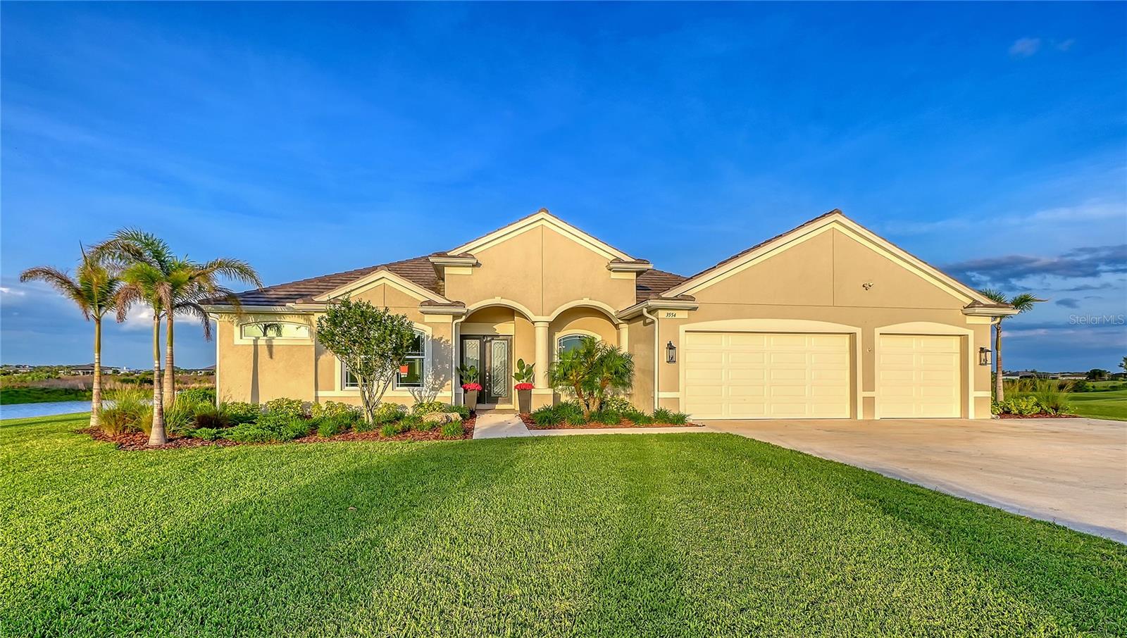 An exceptional estate tucked away in the peaceful Hampton Lakes community of Sarasota is waiting for its new owner!  Situated on a breathtaking 3-acre homesite with a beautiful pond setting, this property offers the perfect balance of privacy, space, and modern convenience—just minutes from Waterside Place and the vibrant amenities of Lakewood Ranch. Enjoy daily encounters with Florida’s natural wildlife, creating a serene and ever-changing backdrop right in your own backyard.

From the moment you arrive, the stately presence of the home with hurricane impact windows and doors and 3-car garage set the tone for what’s inside. Step through the double front doors into a light-filled foyer, where beautiful luxury vinyl flooring flows throughout the thoughtfully designed open floor plan. To the right, a sophisticated dining room showcases a tray ceiling, grasscloth wallpaper, and custom lighting—perfect for hosting elegant dinners. To the left, a private office with double doors offers a quiet workspace with serene front yard views.

At the heart of the home, the gourmet kitchen is both stylish and functional, featuring light cabinetry, quartz countertops, a subway tile backsplash, double ovens, an induction cooktop, and an area that serves as a breakfast bar in the beautiful kitchen. Nearby, a spacious laundry room with an oversized mudroom and additional storage adds everyday convenience.

Designed for seamless indoor-outdoor living, the main living areas are filled with natural light and open effortlessly to the lanai through sliding glass doors. Enjoy tranquil water views from nearly every angle, including the inviting living room with an aquarium window. The expansive bonus room at the rear of the home offers endless possibilities, complete with high ceilings and pocketing sliders that fully open to the outdoor living space—ideal for entertaining or relaxing.

Step outside to your private retreat, where the pool/spa and lanai overlook the picturesque pond and surrounding nature, offering a peaceful setting for gatherings or quiet evenings at home. The outdoor kitchen was newly installed in 2025 with a new TV (2025) to enjoy while being in the Spa!

The luxurious primary suite is a true escape, featuring a tray ceiling, custom closets, and a spa-inspired bathroom with quartz countertops, dual vanities, and generous storage. Three additional bedrooms provide comfort and privacy for family and guests alike.

This is more than a home—it’s a lifestyle. Experience the perfect blend of space, elegance, and tranquility at 3554 Recurve Circle.