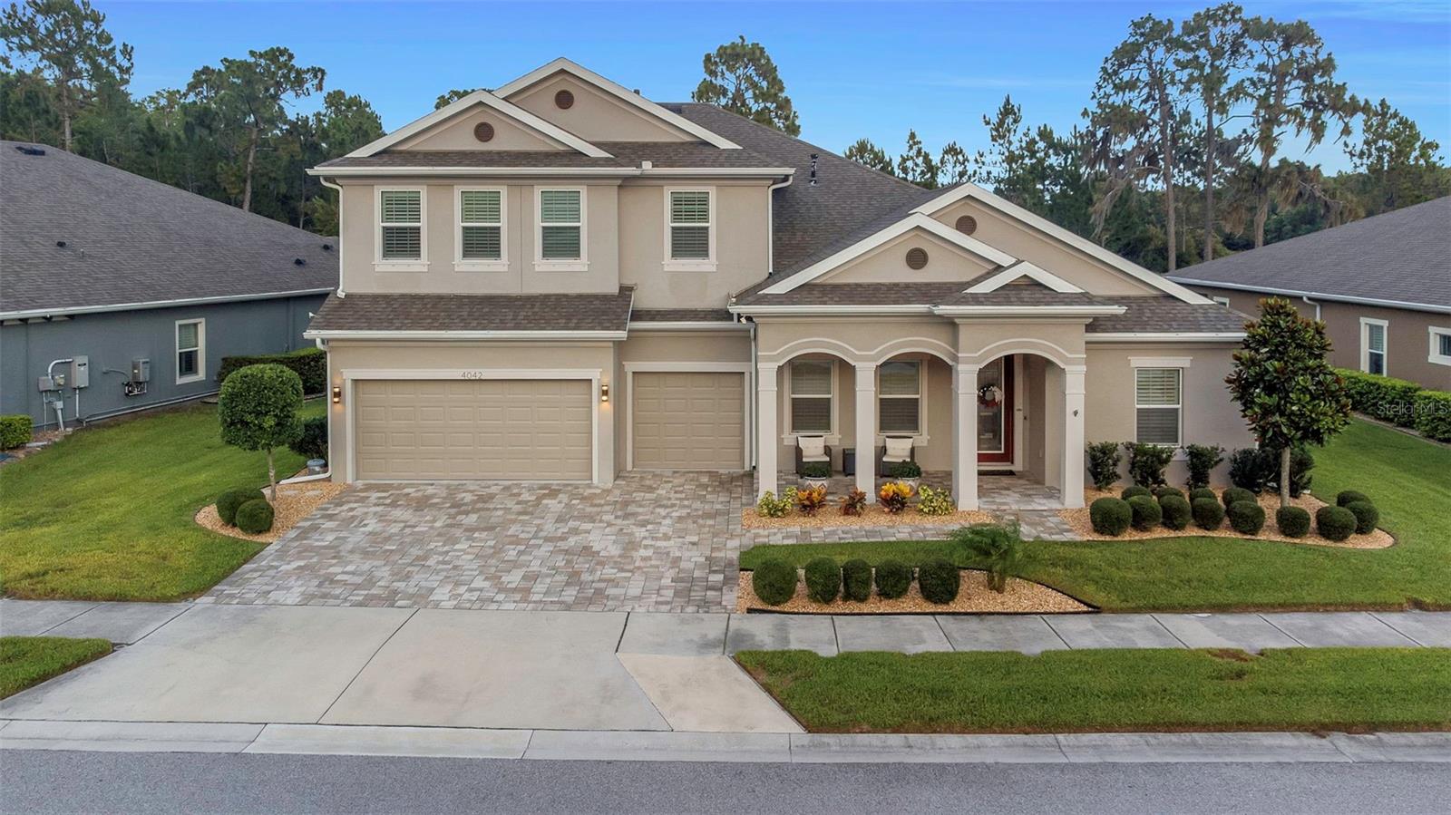 Beautifully landscaped 5-bedroom, 4-bath home with a 3-car garage situated on an oversized lot backing to a private preserve for exceptional privacy and views. Located in a quiet, gated community of well-maintained homes, this newer residence offers luxury finishes, abundant space, and thoughtful upgrades throughout.

Designed for multi-generational living, the home features two full primary suites with spacious bathrooms and walk-in closets. The open-concept great room showcases soaring 12-foot ceilings with decorative wood beams, a stunning floor-to-ceiling stone accent wall, and an expansive 18' x 8' sliding glass door that seamlessly connects indoor and outdoor living spaces.

The gourmet kitchen is a showpiece, featuring a massive island with extended dining space, quartz countertops, upgraded stainless steel appliances, natural gas cooktop, large vent hood, and a custom beverage and serving station complete with wine refrigerator, granite countertops, LED lighting, and extensive cabinetry.

The elegant entry foyer welcomes guests with tray ceilings, double crown molding, upgraded chandeliers, wainscoting, decorative columns, and custom finishes. Bathrooms feature floor-to-ceiling tile showers, upgraded fixtures, and custom wood-trimmed mirrors.

Upstairs, a large game room and sitting area provide the perfect space for entertaining, highlighted by custom wall treatments, floating shelves, and a dramatic floor-to-ceiling stone media wall.  Upstairs also includes one bedroom and one full bath.

Step outside to your private resort-style oasis featuring a fully screened lanai, large saltwater pool, oversized jetted spa with waterfall, decorative water features, color-changing LED lighting, and ample space for relaxing or entertaining. The outdoor living area includes a beautiful stone fireplace wall with mounted television, creating the perfect gathering space year-round.

Additional upgrades include plantation shutters throughout, ceiling fans in every room, 8-foot interior doors on the main level, epoxy-coated garage floors, whole-house water filtration and softener systems, dedicated office with tray ceiling and custom millwork, large laundry room with extensive cabinetry, and abundant storage throughout.

This exceptional home combines luxury, functionality, privacy, and resort-style living in one of the area's most desirable gated communities.  Please ask for a full list of features and upgrades, to many to list.