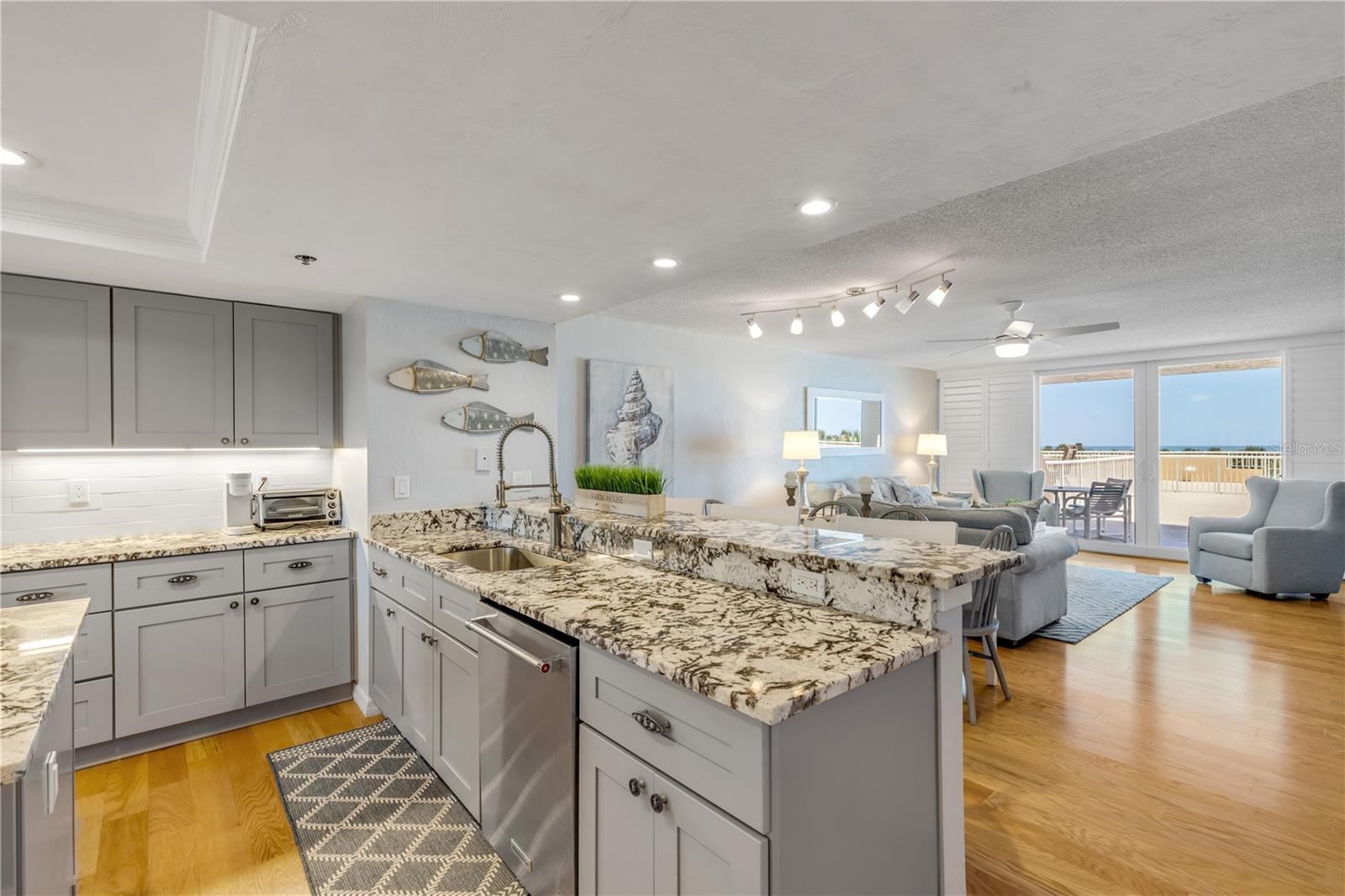 This tastefully renovated Direct Oceanfront condo home with views of the water and beach will please families with pets with it's ease to walk out to the patio and to the beach or pool.  This condo home comes turnkey - beautifully furnished and has great rental income potential.  Some upgraded features include granite, wood-style flooring and stainless steel appliances.  The beach life and entertaining come easy with the huge 31x45 foot balcony with amazing views from the kitchen, living area, and master bedroom.  The oceanfront community of Minorca is one of the most desireable complexes in New Smyrna Beach.  It offers 24-hour security, on-site management/office, multi million dollar clubhouse, 4 lighted Har-Tru tennis courts, private poll for Inlet Building, spa & saunas, beach access with oceanfront pavilion and gated river access to fishing pier and boat docs.