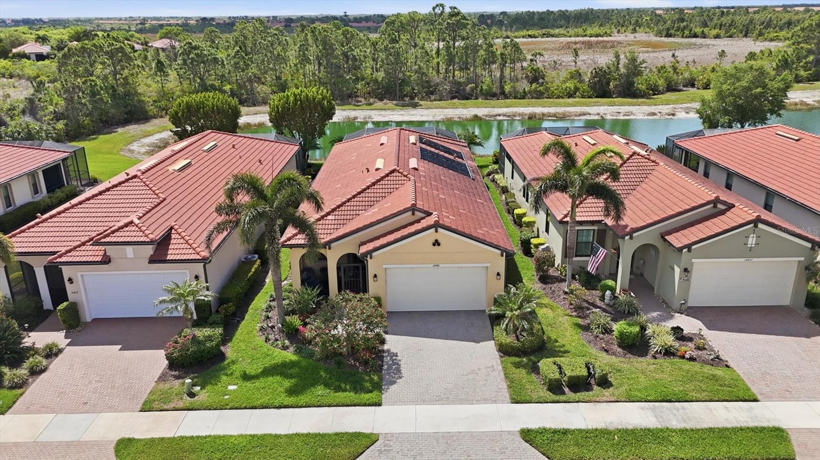 WELCOME to this GORGEOUS home in Sarasota National!  This WCI built home is bright and cheery with neutral decor  Sitting on a FANTASTIC lot offering PANORAMIC VIEWS of LAKE and PRESERVE and SPECTACULAR SUNSETS!  Enjoy the PRIVACY with no homes behind.  Your lanai and PRIVATE POOL create a TROPICAL OASIS for casual occasions or entertaining friends. SOLAR PANELS HEAT THE POOL so it can be used at anytime without waiting to heat up. Great curb appeal as you drive up to the home with pavered drive and Tropical Landscaping.  Screened in front porch and leaded glass designed front door are highlights. Walk into the foyer which leads to the spacious living room. This flexible space can be used in multiple ways from the current use of living room to office/den/study and everything in between. Through the arched doorway to the heart of the home.  The very open great room which combines kitchen, dining, and family room into a functional space of use with elegant designs. BEAUTIFUL kitchen with GRANITE counters, STAINLESS STEEL APPLIANCES, 42 inch white cabinetry,  PENDANT LIGHTS, EXTRA RECESSED LIGHTS,  AND Center ISLAND with FARMERS SINK.  TILE floors throughout the home.  PLANTATION SHUTTERS grace all the windows.  CROWN MOLDING.  Master Bedroom with en suite bath.  Dual sinks and Walk in shower with tile to the ceiling, listello, and open glass enclosure.  CUSTOM DESIGNED CLOSETS.  Guest bed and bath at other end of the home for for everyone's privacy.   UPDATED FANS AND FIXTURES throughout the home. Laundry room with cabinets and wash sink. No need to worry about hurricanes.  STORM SMART SHUTTERS ON LANAI AND FRONT PORCH.  ACCORDION HURRICANE SHUTTERS ON WINDOWS.  Come and see this MAGNIFICENT HOME.  LIVE YOUR DREAM and FIND YOUR FLORIDA LIFESTYLE.  Property is on the NON GOLF side of Sarasota National.  NO GOLF FEES OR MEMBERSHIPS REQUIRED.  Sarasota National is a VIBRANT AND ACTIVE community with over 1300 acres designated for preservation, conservation, lakes, and open space with amazing views, Proclaimed as an Audubon International Certified Sanctuary, making it the most gorgeous and enjoyable golf course to play at in the area. Offering resort style amenities with huge resort style pool and spa,Tiki Bar to serve refreshing drinks and a bite of lunch, tennis courts, pickle ball, Bocce courts, coffee lounge/library/card room/meeting place, 7000 sq ft fitness facilities offering classes and day spa, and a 30,000 sq ft Clubhouse with dining and spectacular views. 18 Hole championship golf course surrounded by native wetlands and preserves provides an exhilarating and dramatic back drop for your golfing adventure. Minutes away from the new Wellen Park shopping area and Atlanta Braves stadium. Venice Beach and Venice Downtown are just a short drive. Your choice of restaurants and outdoor activities await. DON'T WAIT!! TODAY IS THE DAY YOU FIND YOUR NEW HOME!