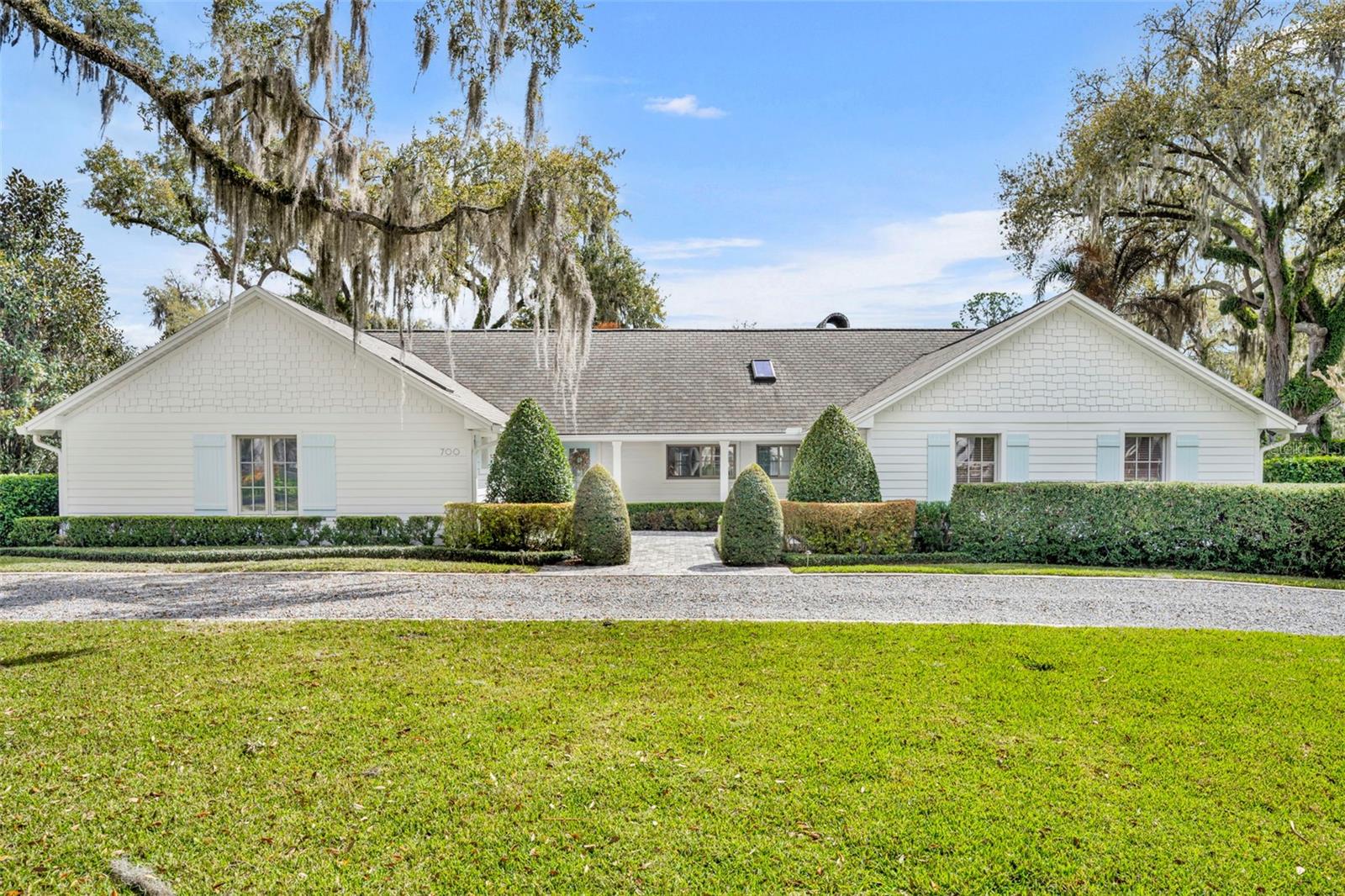 Located in the desirable heart of the Via's, this single story home with a transitional interior in Sicilian Shores is a meticulously renovated Winter Park charmer. Nestled quietly on an almost 1/2 acre corner lot, this beautiful home is walking distance to the Winter Park Racquet Club and easy proximity to Park Avenue and Interlachen Country Club. Complete with a gracious master bedroom adjacent to an eloquent sitting room and walk in closet, a secondary master sized bedroom, two beautiful guest bedrooms, en suite bathrooms for all bedrooms, and half bath, this floor plan is the perfect design for any living configuration. With the exception of one guest bathroom, the entire home has been redone with wood look tile from Italy throughout and a plethora of custom upgrades and style features. An elegantly appointed kitchen, laundry, tiled and screened porch (with added gas fireplace and television), stunning master bath, built-ins, and large gas burning fireplace in living room are among the many special features of this stunning single story residence. With plenty of natural light and well-maintained landscaping, 700 Pinetree is perfectly appointed for Winter Park living at its finest. Exterior includes fenced dog run with turf, gated back yard, pool, lighting, sprinkler system, pavers, and mature privacy landscaping. Appliances include GE Cafe and Sub Zero. Natural gas, LED lighting throughout, and custom electronics in fourth bedroom turned media space. California closet in a true master suite with freestanding tub and plenty of storage, high volume and tray ceilings, skylights, integrated home generator, and a six year old roof add to the appeal of this stunning corner property. Elegance, privacy, and sophistication, combined with quality finishes and touches makes this home a true gem!