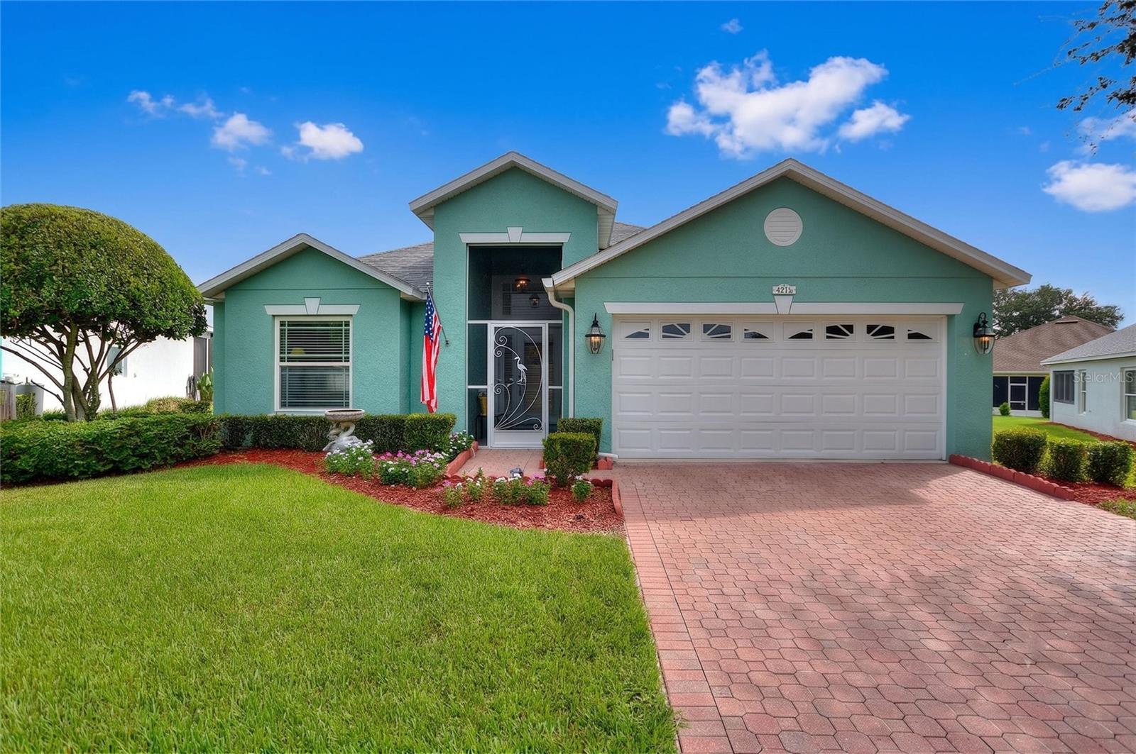 Welcome to this beautifully maintained, energy-efficient 4-bedroom, 3-bath home in the highly desirable Traditions at Ruby Lake, a premier 55+ gated community offering the very best of Florida resort-style living.

Situated on an oversized lot, this exceptional home features a desirable split floor plan Jack and Jill bathroom w/ walk-in tub and soaring high ceilings that create a bright, open, and spacious feel throughout. Thoughtfully upgraded for both comfort and efficiency, the home offers a spacious, expanded screened lanai with brick pavers—the perfect outdoor retreat for entertaining or enjoying a quiet evening—enhanced by customizable LED lighting to create the ideal ambiance. Energy-saving features include foam-core insulation in the concrete block walls, new Andersen windows, and a freshly painted exterior.

Inside, you'll find hardwood flooring in the primary bedroom and front bedroom, which also makes an ideal home office. The kitchen is beautifully appointed with custom cabinetry, granite countertops, slate stainless steel appliances, and abundant storage. Custom maple shelving in the pantry, laundry room, and both linen closets adds both elegance and functionality. The primary bath also features granite countertops, completing the home's high-quality finishes.

Designed for comfortable everyday living and effortless entertaining, this home offers generous living spaces that provide both privacy and flexibility for family and guests.

HOA dues provide exceptional value and include weekly lawn and landscape maintenance, Spectrum TV service, and exterior house painting every seven years. Residents also enjoy full access to the community's impressive lakefront clubhouse, featuring a resort-style pool and spa, sauna, showers, a fully equipped fitness center, staffed front desk, library, business center, billiards room, craft room, and a spacious ballroom that hosts meetings, dances, entertainment, guest speakers, clubs, and social events.

Outdoor amenities are equally impressive and include tennis, basketball, bocce ball, shuffleboard, pickleball, three community boat docks, a picturesque lakeside gazebo, and a paved walking path along the lake—perfect for morning strolls or evening exercise.

If you're looking for a move-in-ready home with exceptional upgrades, low-maintenance living, and an active, resort-style lifestyle, this is the one you won't want to miss!