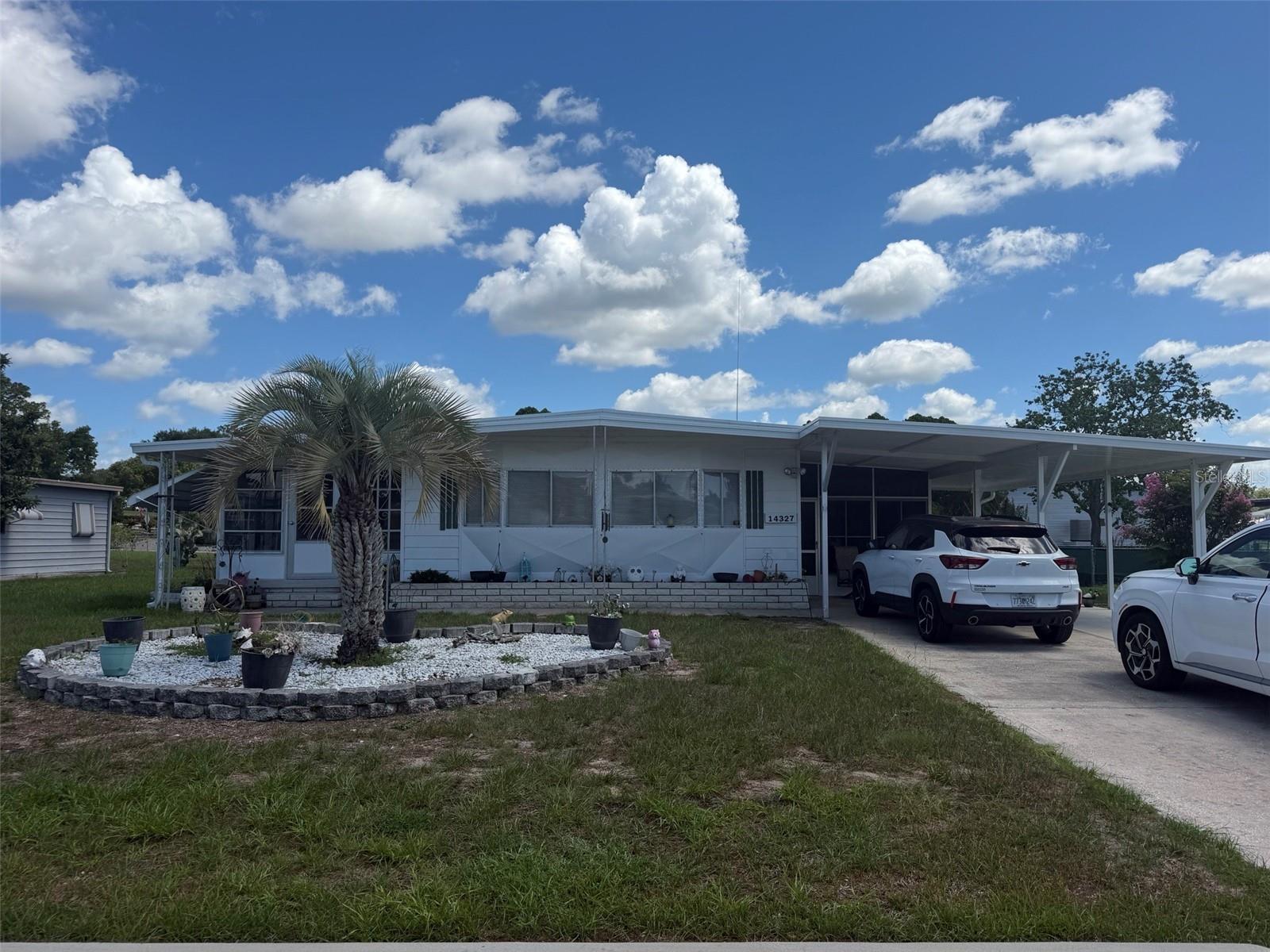 SELLER MOTIVATED! Welcome to the highly sought-after 55+ golf community of Brookridge! The pictures are virtually staged. This spacious double-wide manufactured home offers 2 generously sized bedrooms and 2 full bathrooms, providing comfort and functionality throughout. Step into the bright and inviting living area where two large bay windows fill the home with beautiful natural light. Enjoy relaxing in the oversized sunroom located along the left side of the home, surrounded by windows that let the Florida sunshine pour in year-round. On the opposite side of the home, you'll find a large workshop/laundry area complete with washer and dryer, plus plenty of additional storage space. Outside, a charming screened-in sitting area creates the perfect spot to enjoy your morning coffee or unwind in the evening breeze. This home is full of warmth, character, and space to spread out. Residents of Brookridge enjoy resort-style amenities including a heated pool, 18-hole golf course, clubhouse, fitness center, tennis courts, and a wide variety of active social clubs -- making Florida living easy and enjoyable! Some photos have been virtually staged. Furnishings shown are for illustrative purposes only and may not reflect the property's current condition.